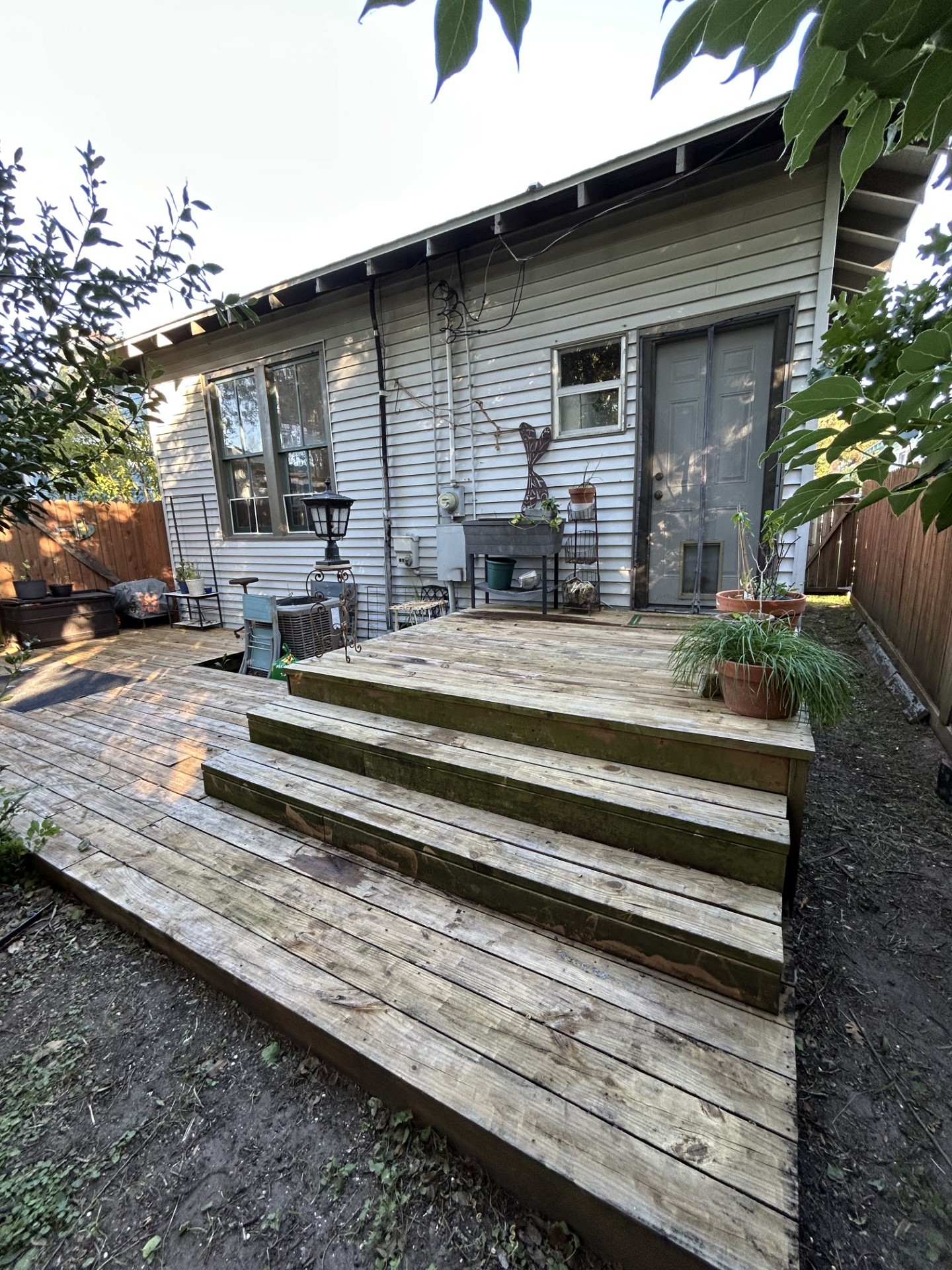 Back of the house showing the steps and the layered back deck.