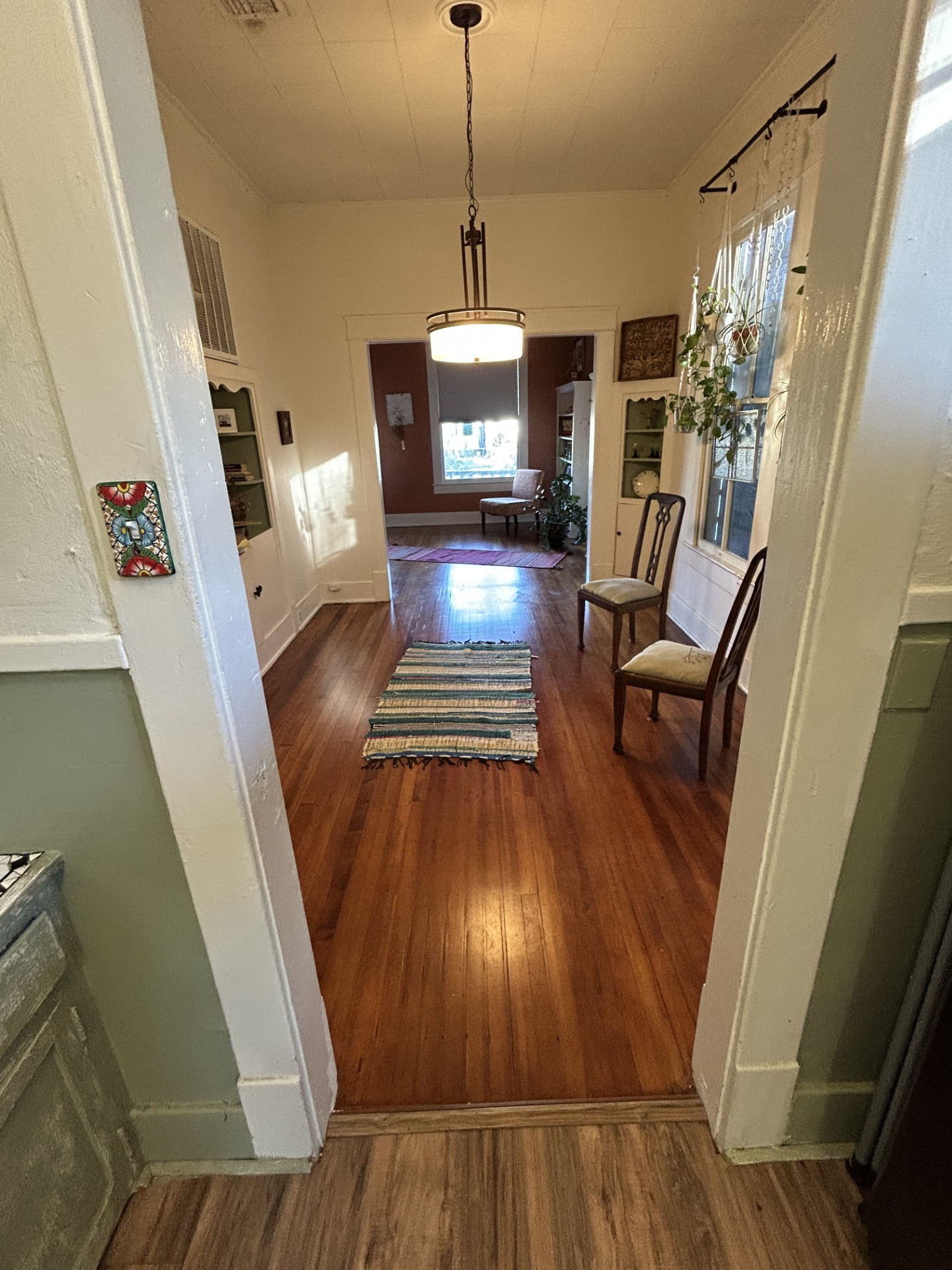 Looking from the kitchen through the formal dining room with the living room in the background.