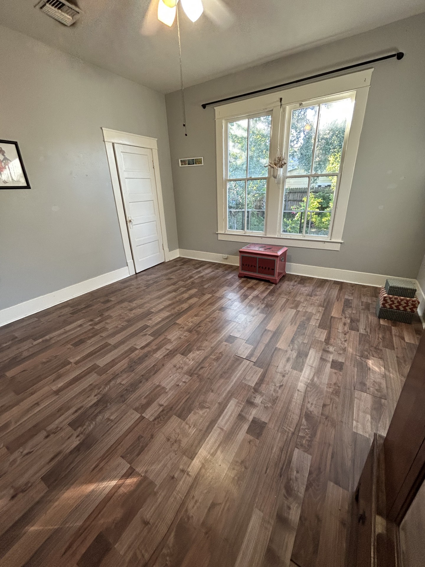 Larger bedroom with closet. Windows look out onto the backyard.