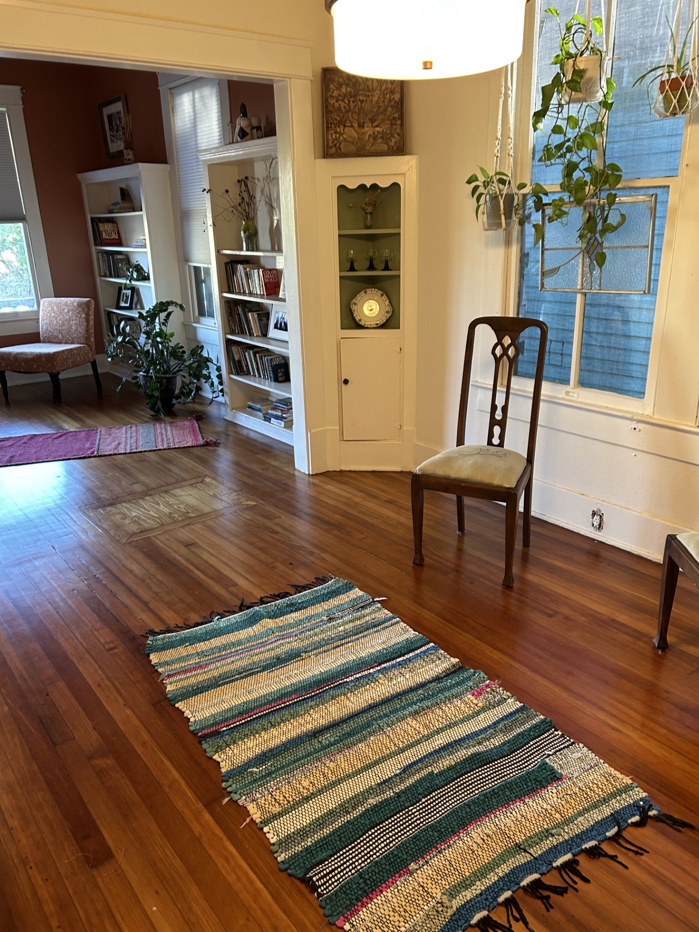 One of the three hutches in the formal dining room with a glimpse into the living room. Beautiful quartersawn longleaf antique pine floors.