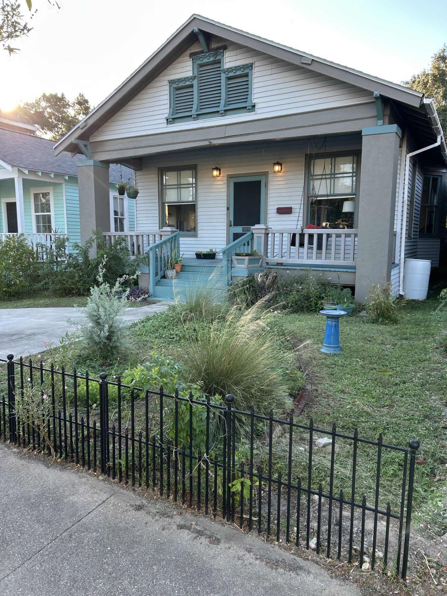 Circa 1923 craftsman-style home with wide front porch. Owner had private driveway installed in front yard.