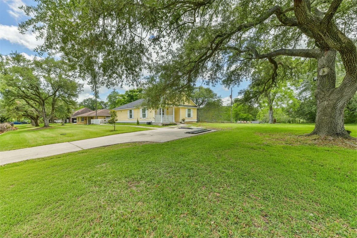 Charming Home nestled on double lot with mature trees.