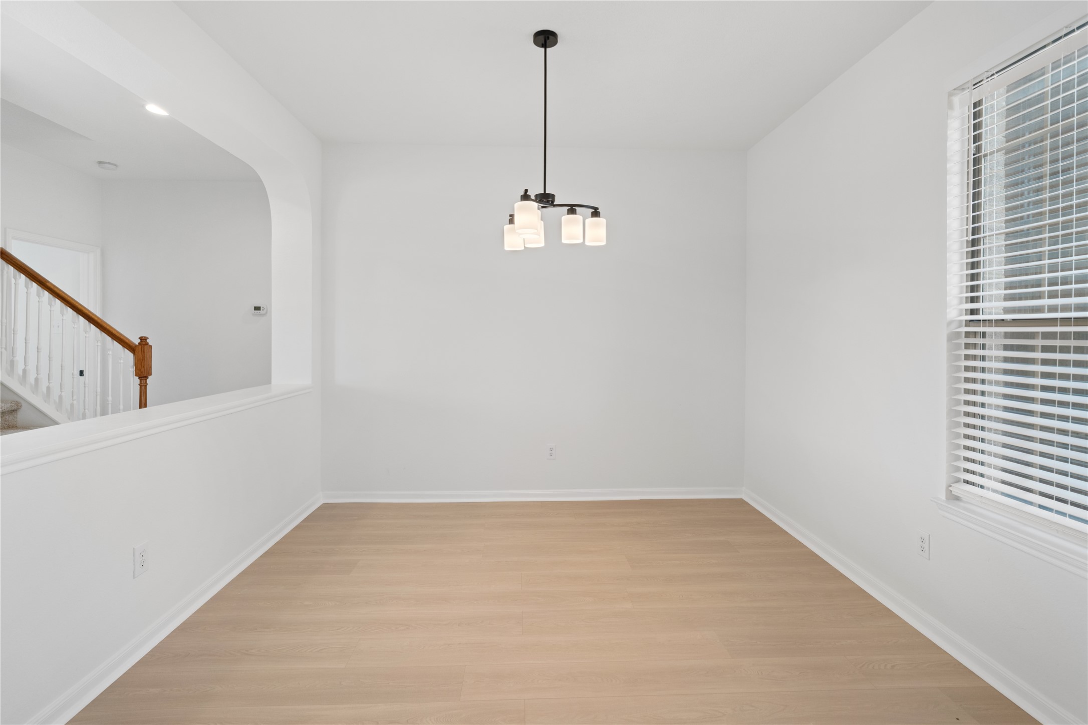 Dining Area Dedicated dining space with light-toned flooring, contemporary pendant lighting, a large window, and an open connection to the adjacent living areas. Dining Area Dedicated dining space with light-toned flooring, contemporary pendant lighting, a large window, and an open connection to the adjacent living areas.