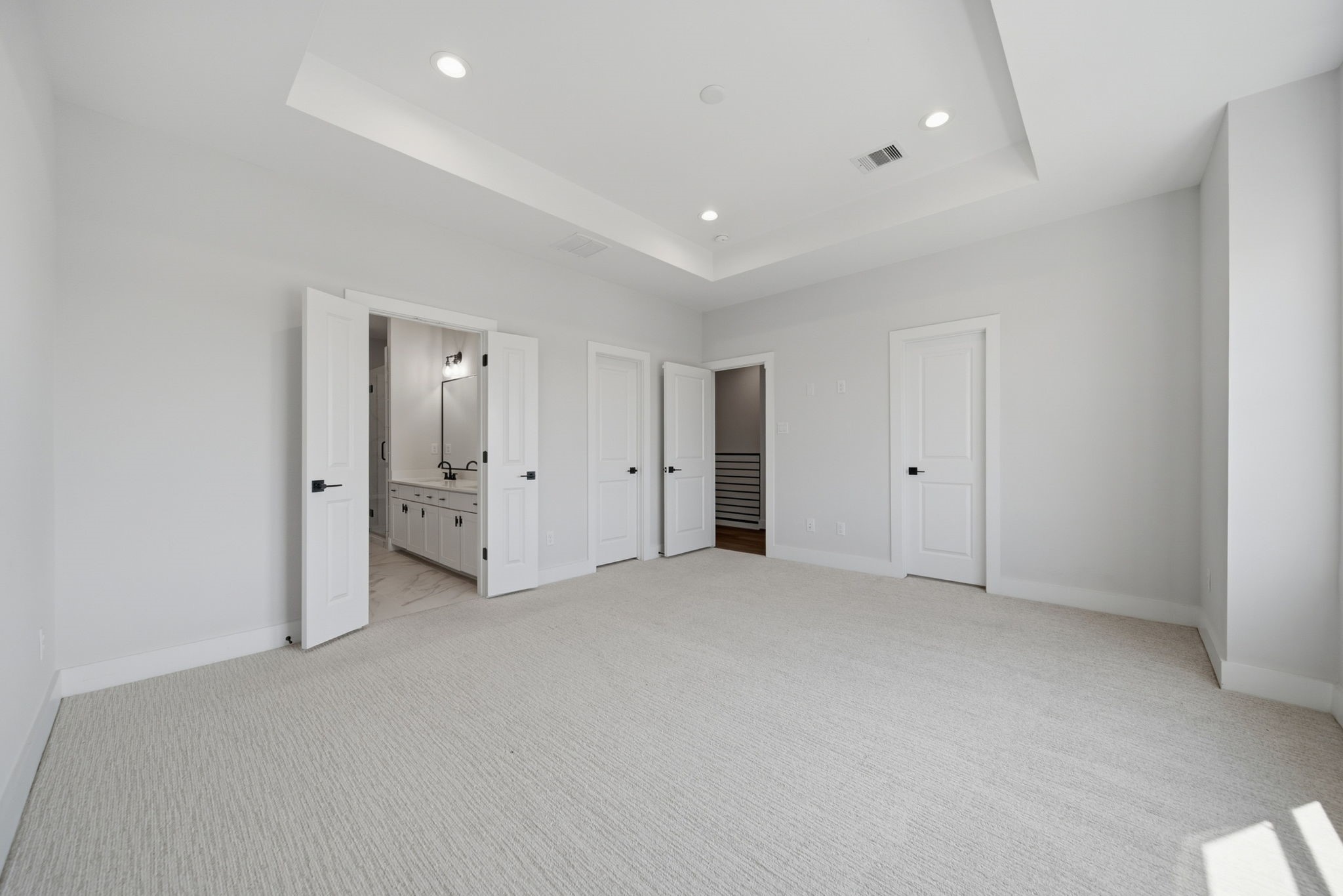 Primary bedroom with lots of natural light.