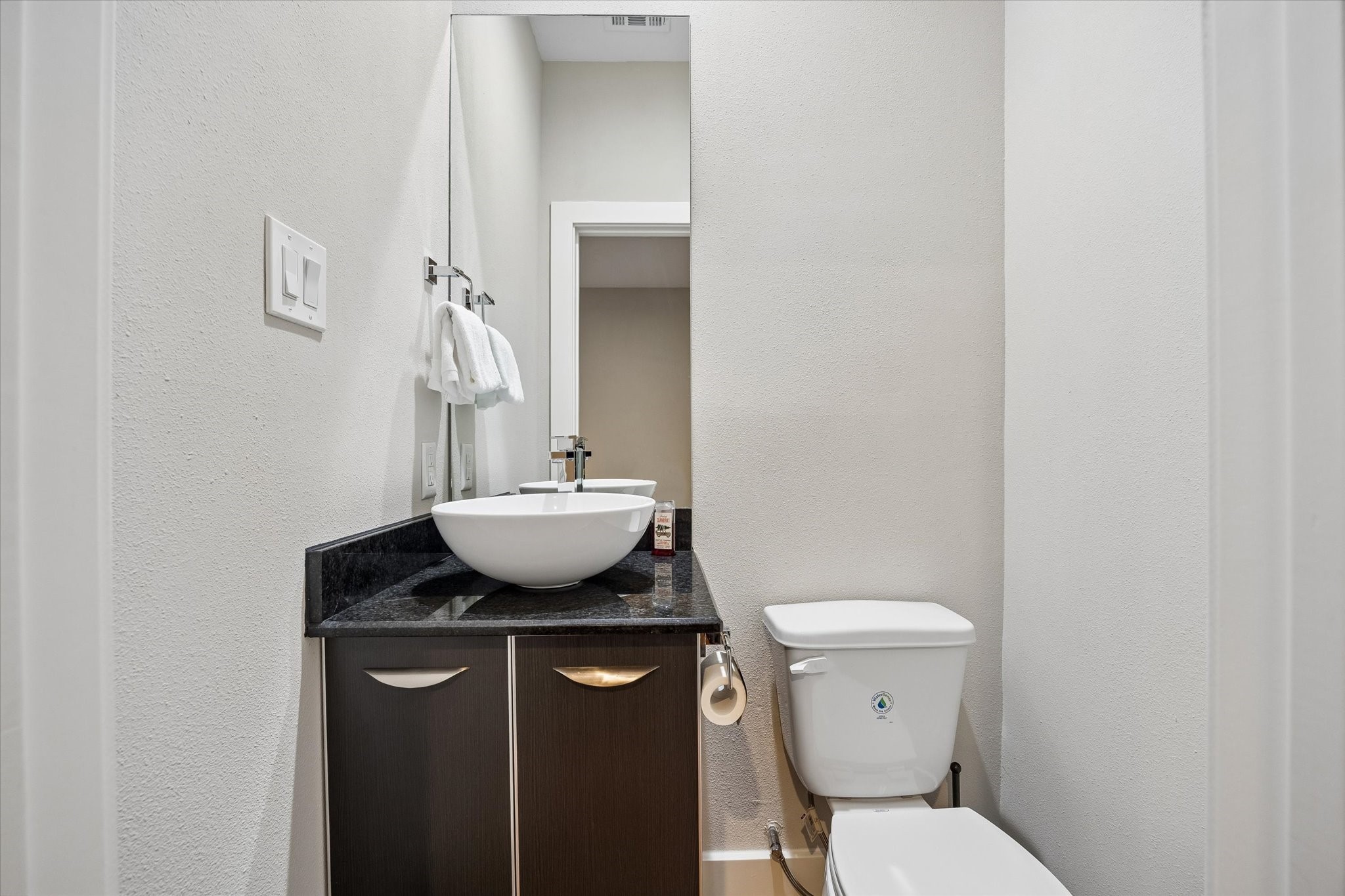 A rare and practical bonus, this second powder bath is conveniently located near the rooftop deck, making it convenient for guests during outdoor gatherings. The sleek vanity and vessel sink keep the look clean and modern while adding even more convenience to this well-designed layout.