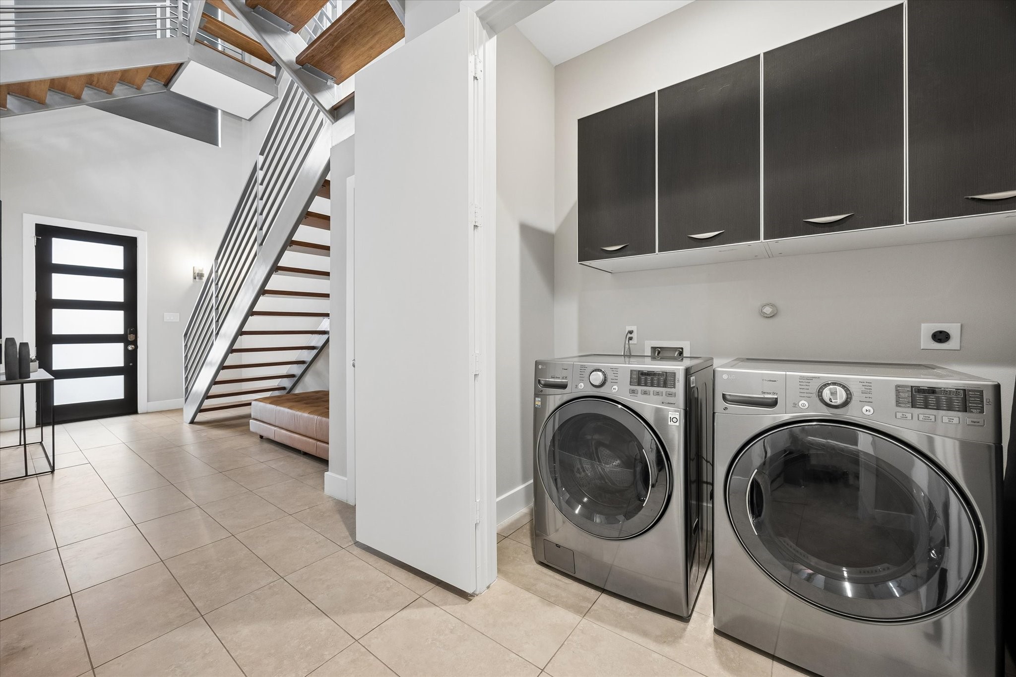 The hidden utility room keeps laundry tucked neatly out of sight while offering built-in storage to help everyday essentials stay organized and easy to access. As an added bonus, the washer and dryer stay!