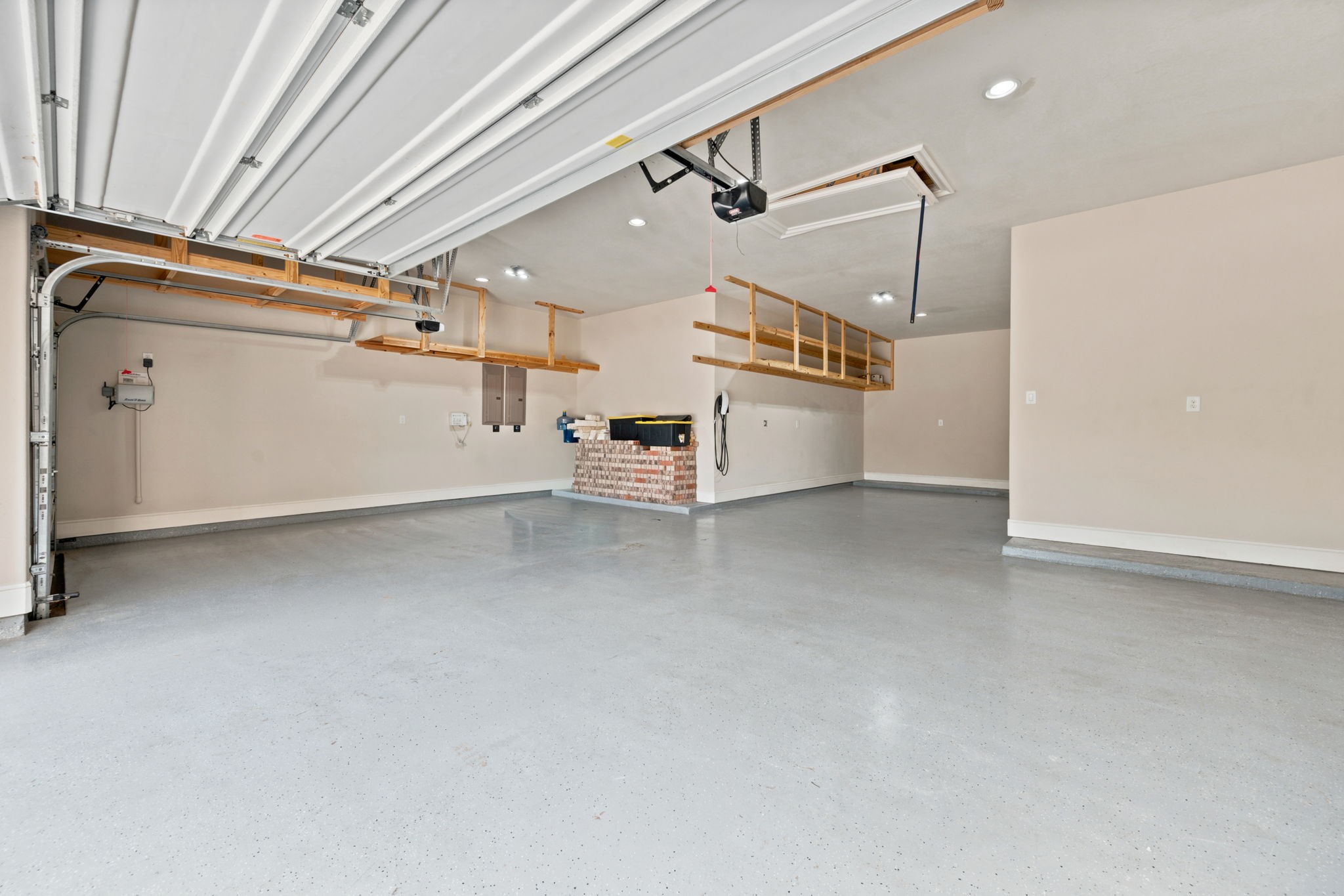 4 car garage!! THE DREAM!! Overhead storage shelving and TESLA Charging station. 4 car garage!! THE DREAM!! Overhead storage shelving and TESLA Charging station.