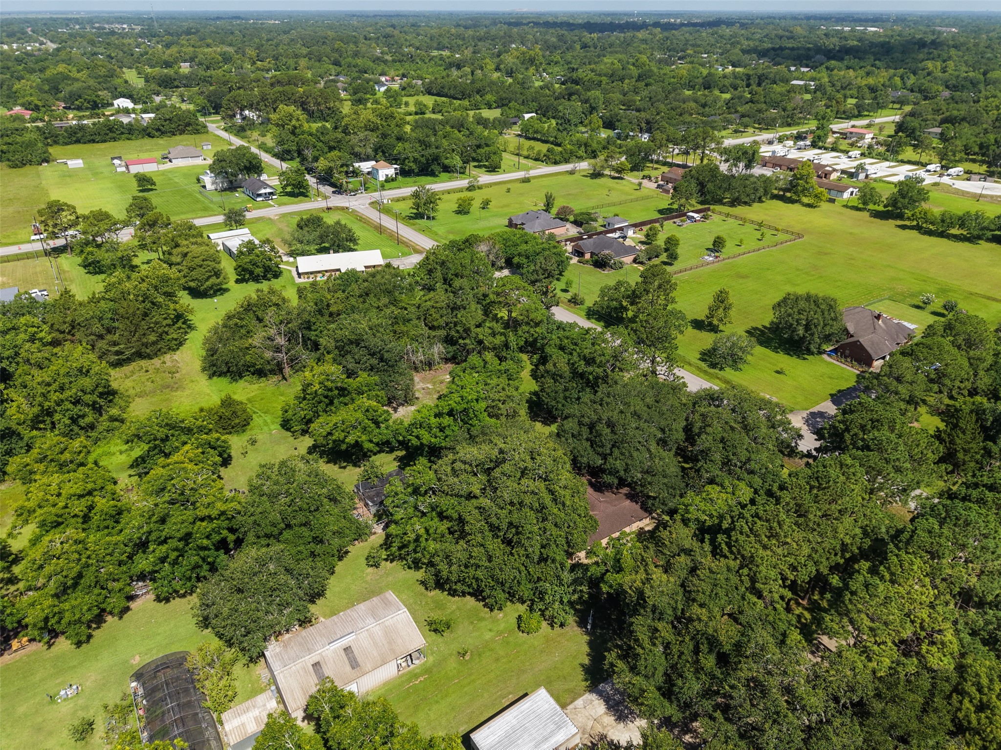 This view illustrates the blend of residential properties, open fields and mature vegetation surrounding the homesite. The property offers the tranquility buyers often seek in acreage while remaining within Santa Fe and convenient to major local corridors. That combination can accommodate a wide variety of lifestylesfrom someone envisioning a private custom home to a buyer wanting additional room for hobbies, equipment or a substantial workshop.