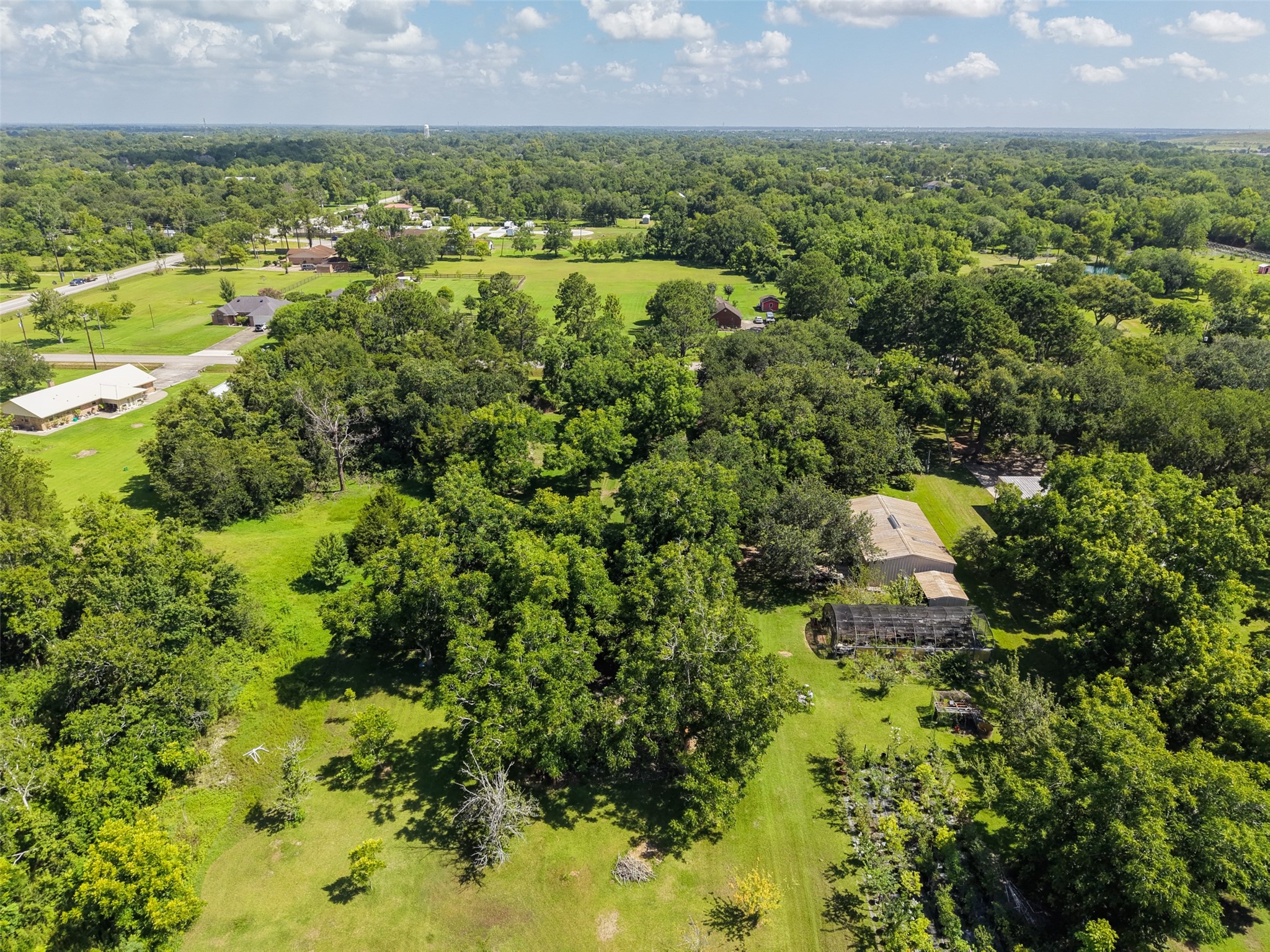 This elevated view demonstrates how the property combines acreage with practical accessibility. Rather than being hidden miles down an isolated road, the tract sits just one lot from FM 646, providing convenient connections to Highway 6 and surrounding communities. At home, however, the mature trees and substantial 612' depth offer the opportunity to create a private setting removed from the activity of the main road.