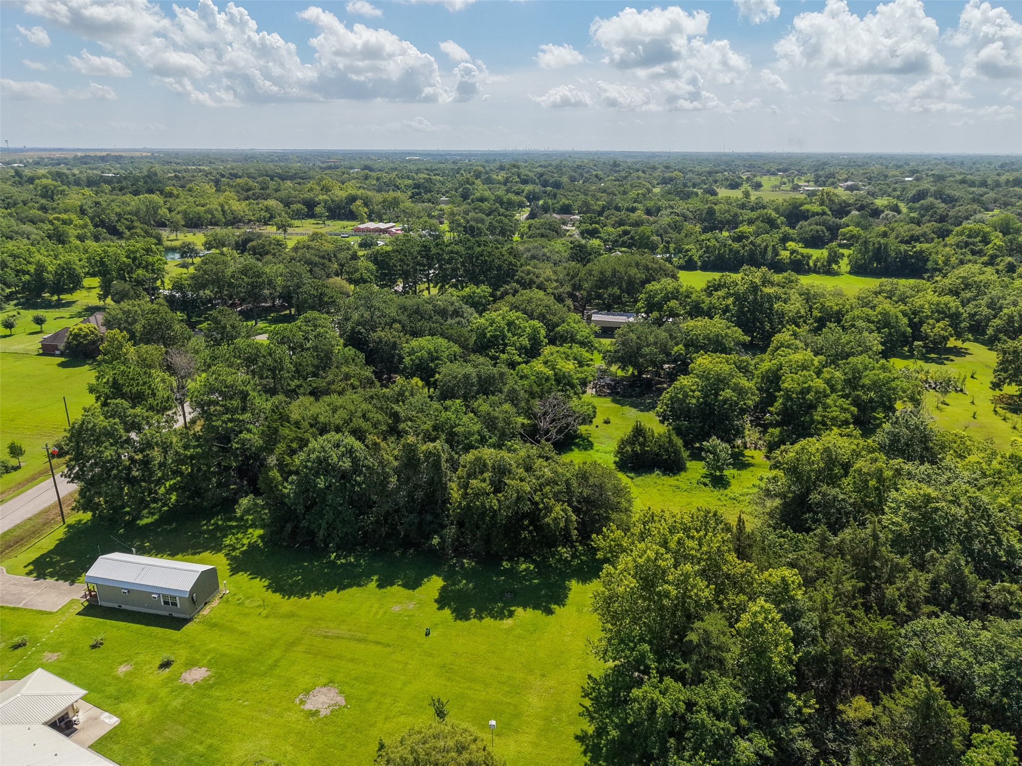 The property's mixture of open ground and established trees provides an attractive starting point for future development. Open areas may lend themselves to a homesite, shop, lawn or recreation, while existing trees can provide natural screening and shade. The property can be used for single-family, multifamily and other potential uses, giving buyers flexibility while independently verifying their intended plans and applicable requirements