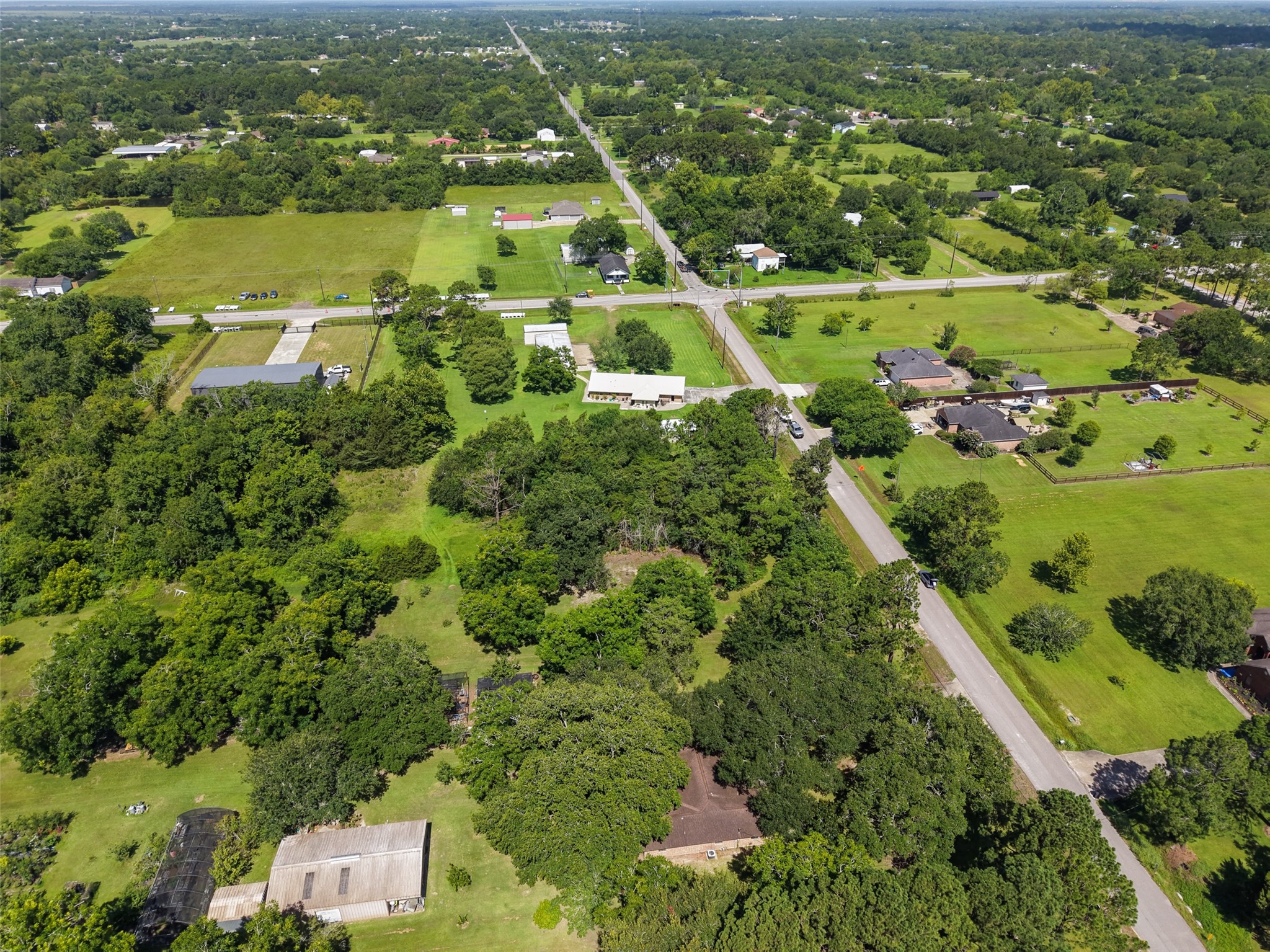 This aerial view highlights the visual depth created by alternating areas of open lawn and dense tree canopy throughout the surrounding landscape. The subject property offers the same appealing natural character, providing opportunities to preserve mature trees for shade and screening while creating open spaces around future improvements. It is an excellent foundation for a homesite designed around outdoor living and privacy.