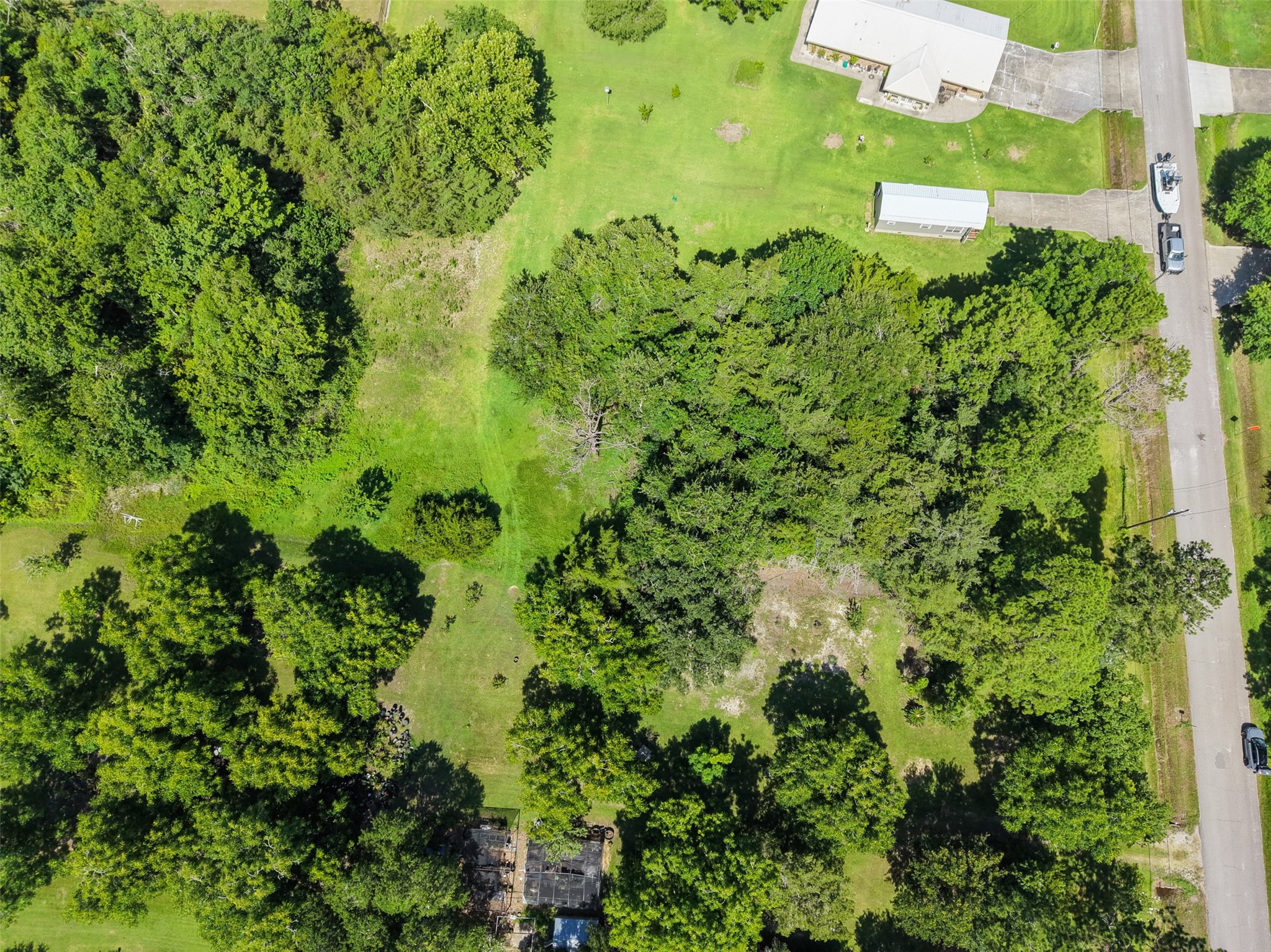 A final overhead perspective captures the defining appeal of this Santa Fe property: 1.56 acres, mature hardwoods, generous dimensions and convenient access in one distinctive offering. The combination of approximately 111' of frontage and 612' of depth provides exceptional flexibility for future plans, while nearby FM 646 and Highway 6 keep groceries, restaurants and everyday services within easy reach.