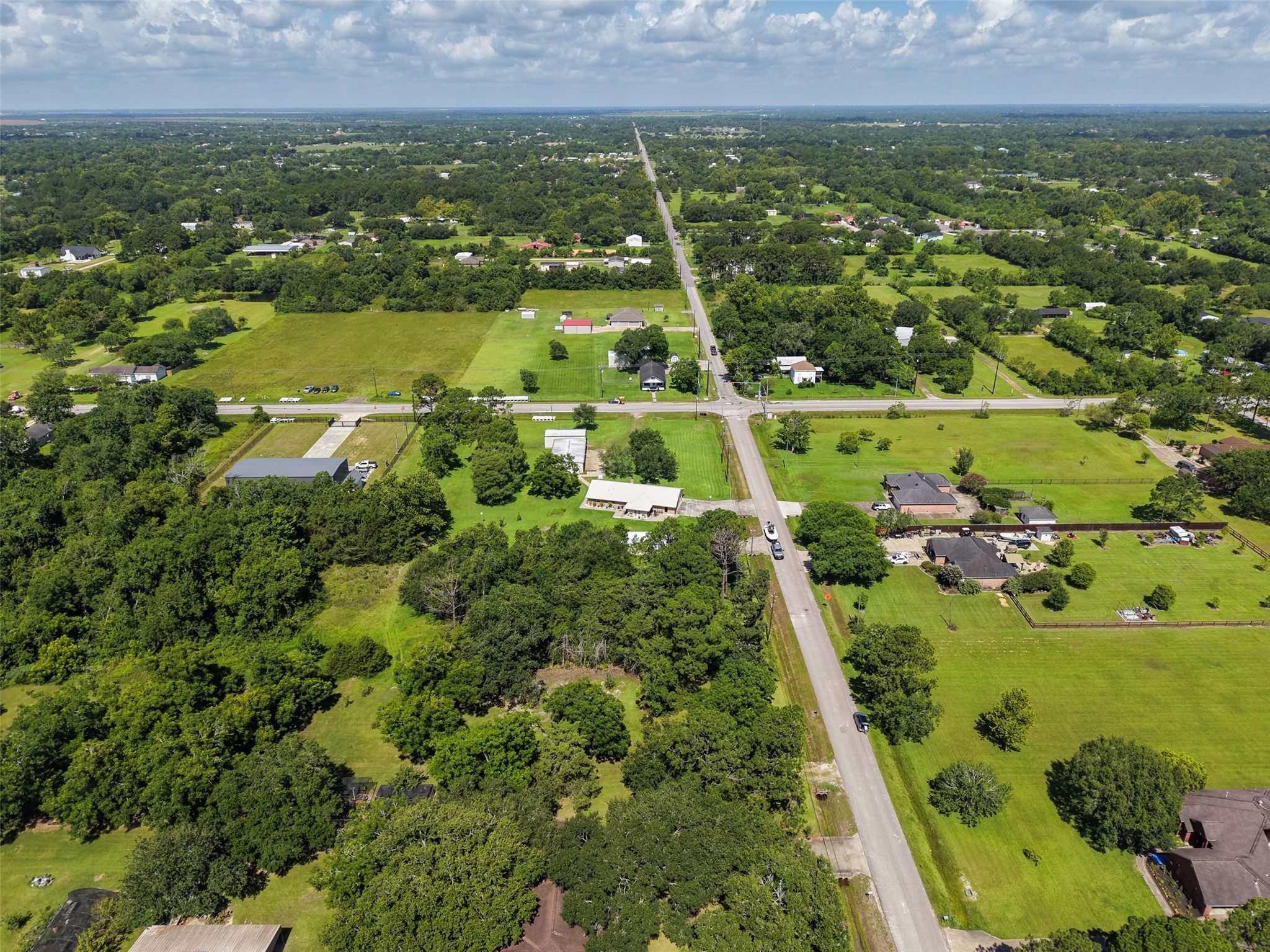This aerial perspective highlights the network of paved roads connecting the property to the surrounding Santa Fe community while maintaining a relaxed country atmosphere. The homesite is just one lot from FM 646, making trips toward Highway 6 straightforward. Once home, the property's 612' depth offers the ability to establish substantial separation from the roadway and create a more secluded residential setting.