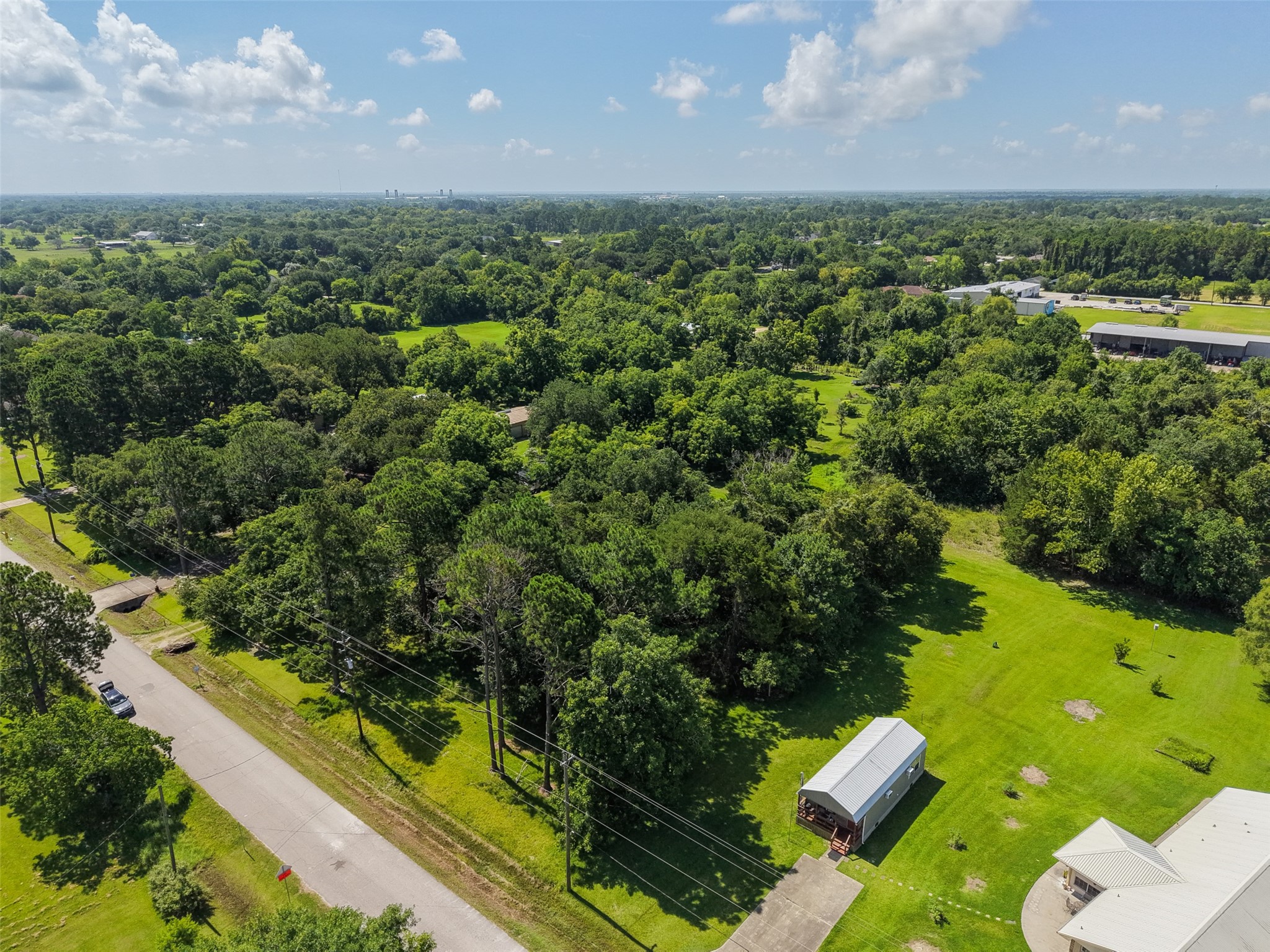 This perspective emphasizes the scale of the property compared with nearby homesites. At approximately 1.56 acres, the tract provides substantial room for a custom residence with space left for a workshop, garden, outdoor entertaining, recreational areas or other improvements. Its location near FM 646 also means the peaceful wooded surroundings don't require sacrificing practical access to Santa Fe's everyday conveniences.