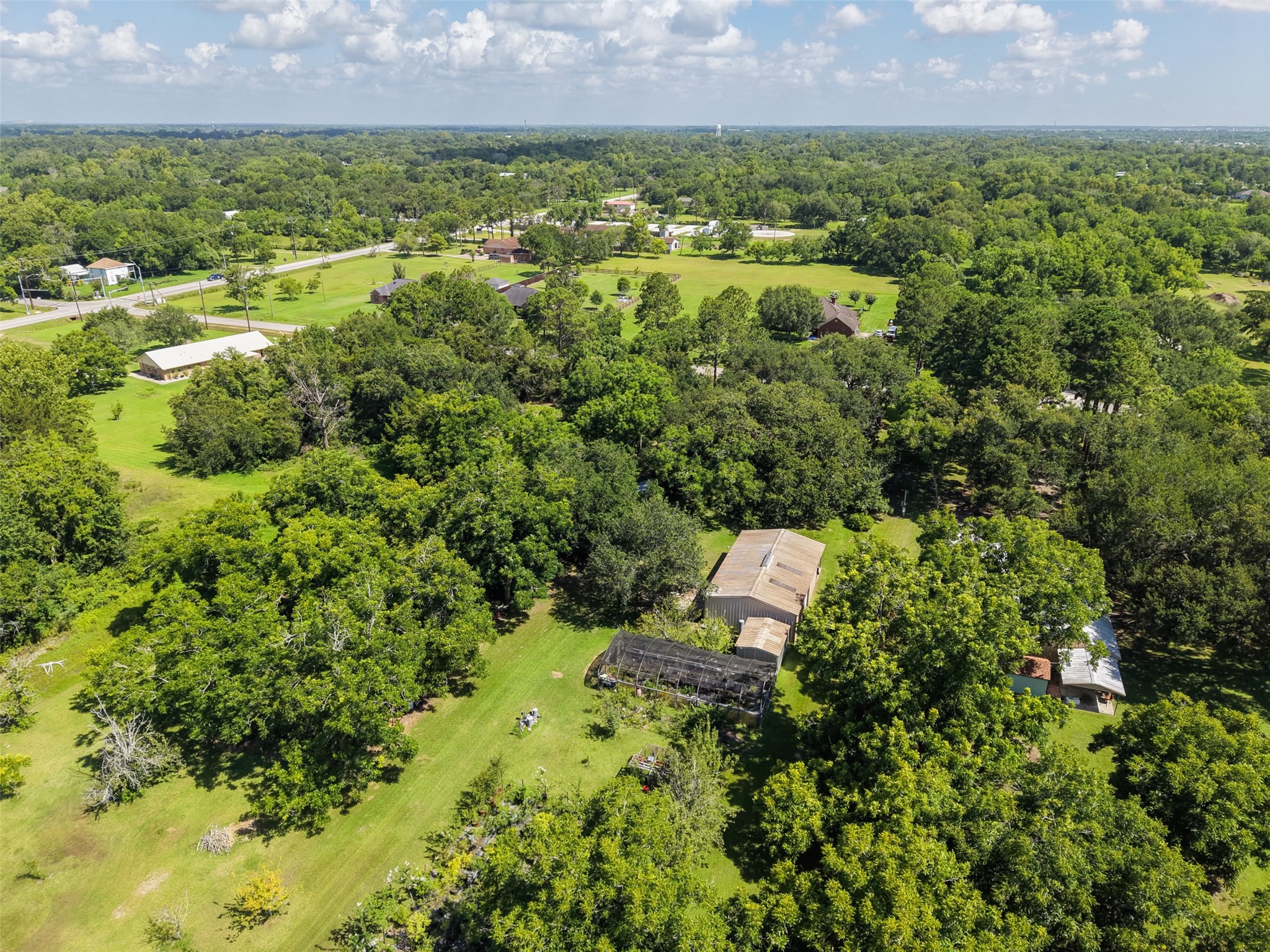 The aerial photography captures an increasingly difficult combination to find: meaningful acreage, established trees and convenient access within Santa Fe. Mature vegetation creates privacy between neighboring properties while broad open areas break up the canopy. The result is a setting that feels rural and established rather than newly cleared, giving a future owner the opportunity to design around the landscape instead of starting from scratch.