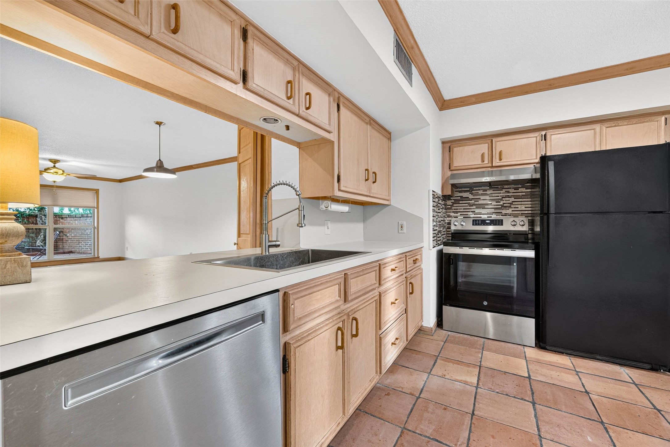 Charming kitchen seamlessly flowing into an inviting open-concept living area.