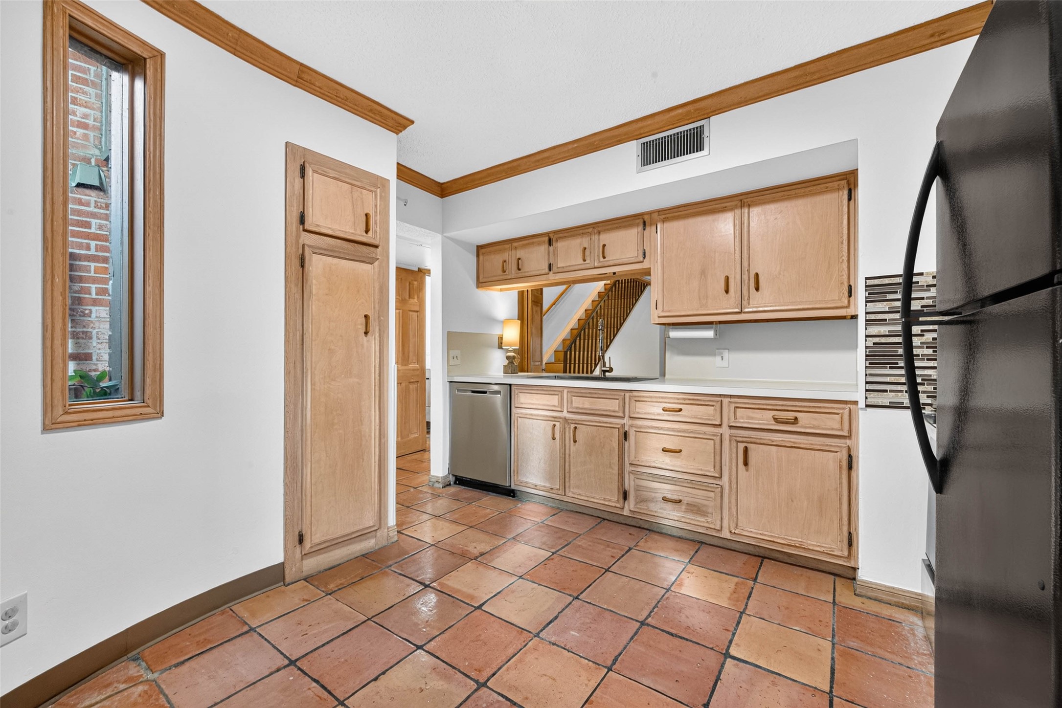 Charming kitchen with warm wood cabinetry, sleek stainless steel appliances
