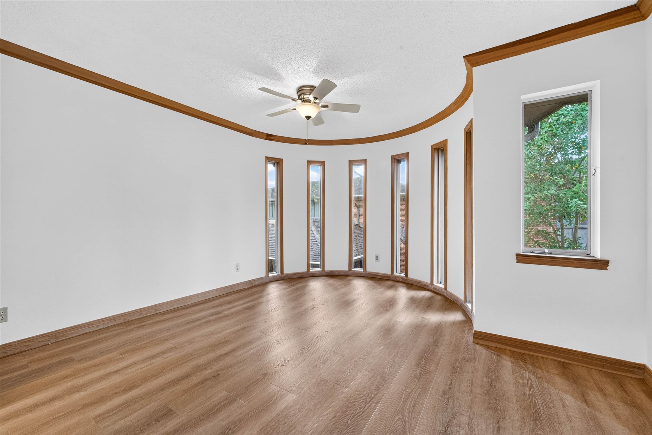 Bright, spacious room with elegant curved windows