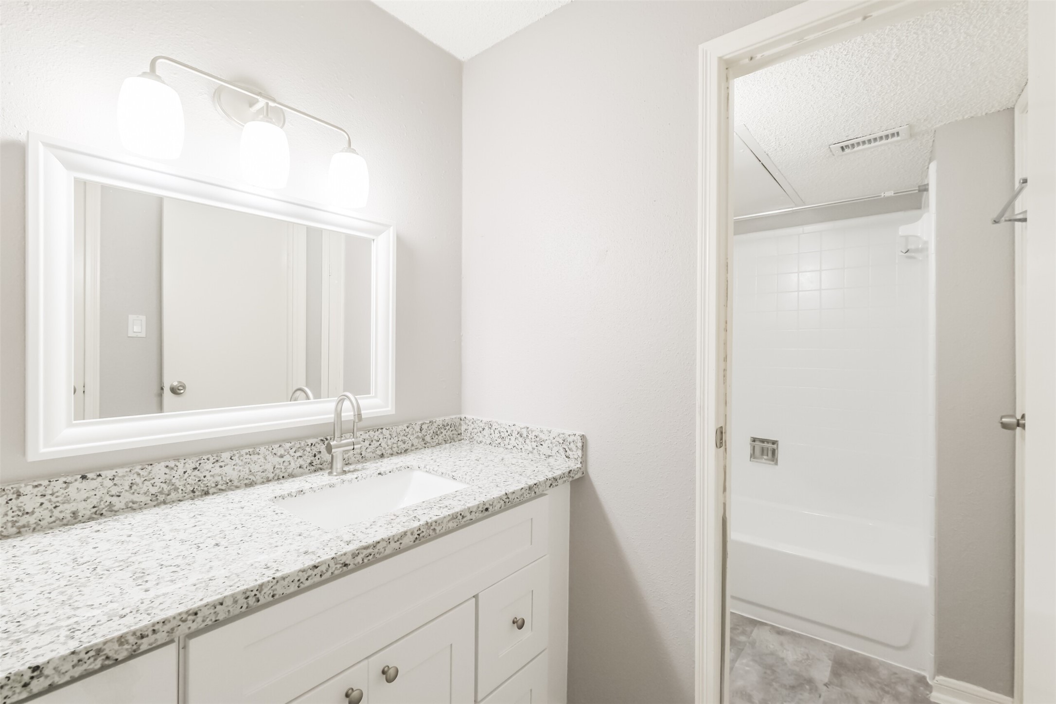 Updated bathroom with granite countertop, conveniently accessible for guests!
