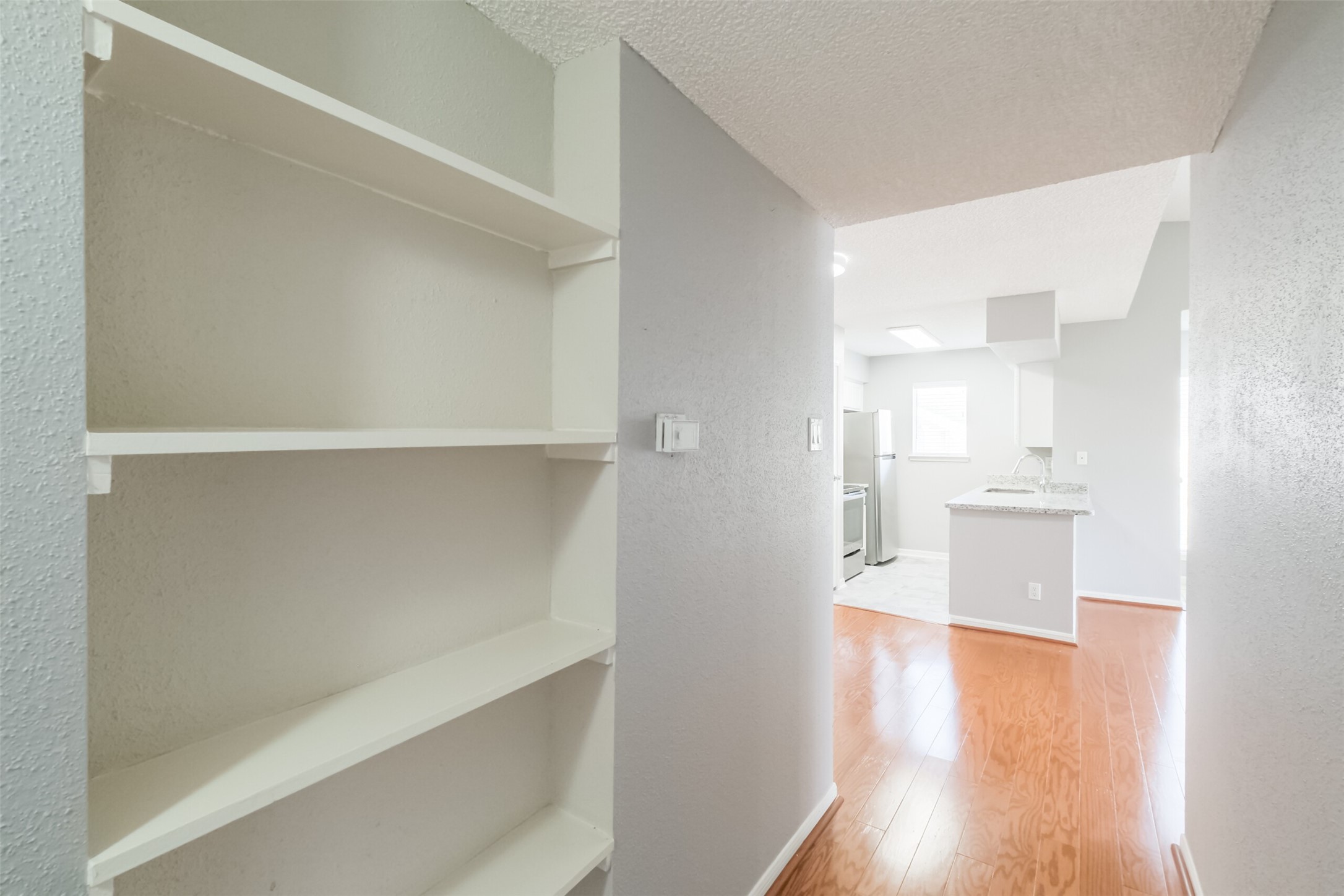 Hallway with extra shelving, perfect for books, decor, or storage!