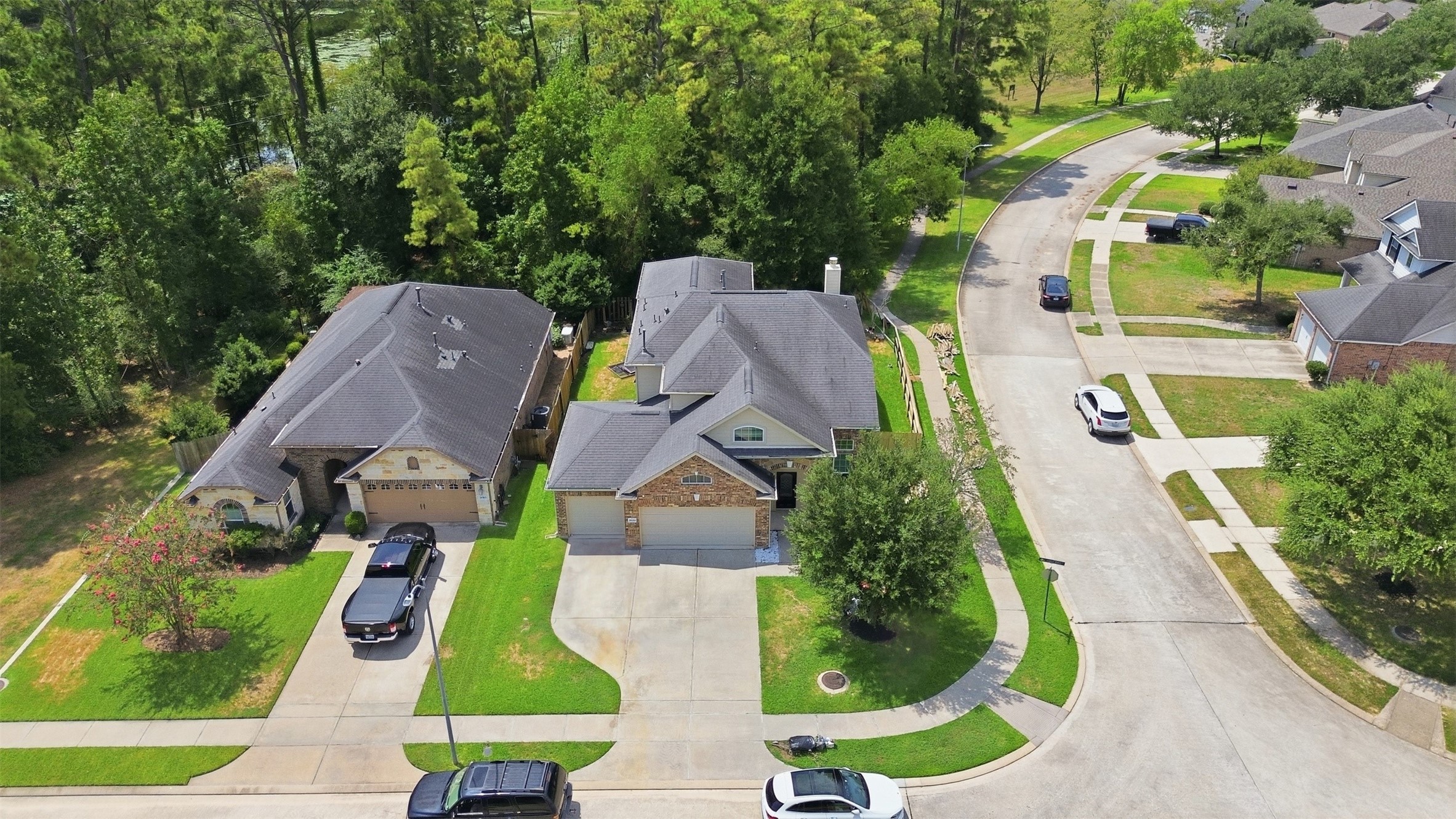 From above, the payoff is clear: no back neighbors, just mature trees, greenbelt and a glimpse of the lake behind the home. A quiet cul-de-sac street out front.