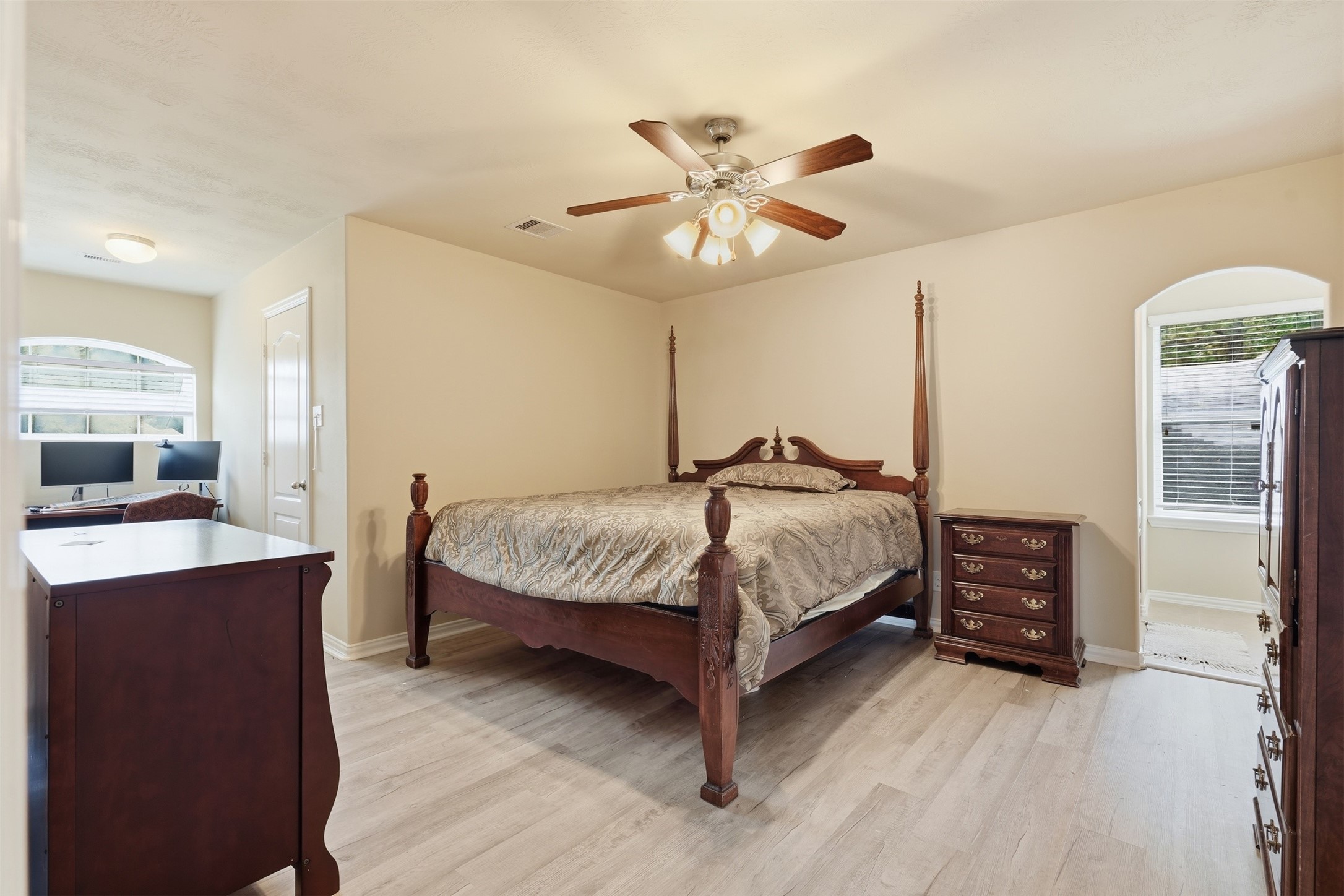 An upstairs bedroom with a bonus: a built-in office nook beneath the arched front window. Work from home without giving up the guest room.