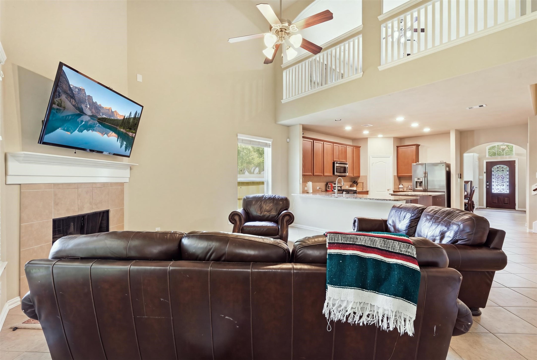 The open-concept payoff: the living room flows straight into the kitchen, with the upstairs overlook above and sight lines all the way to the front door. Hosting just got easy. The open-concept payoff: the living room flows straight into the kitchen, with the upstairs overlook above and sight lines all the way to the front door. Hosting just got easy.