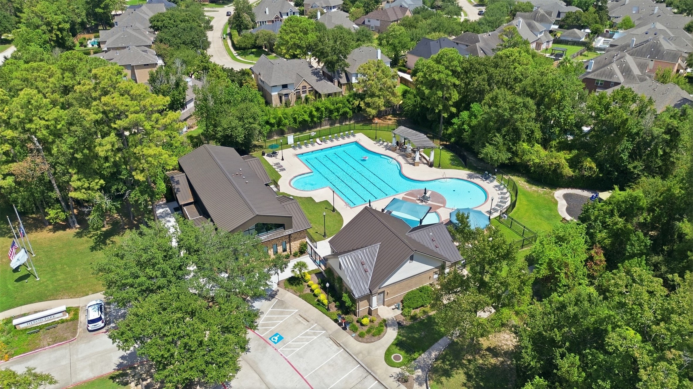 Community perks: the Spring Trails pool at Heron Park, with lap lanes, shaded seating and a playground, plus tennis, pickleball and trails around the community.
