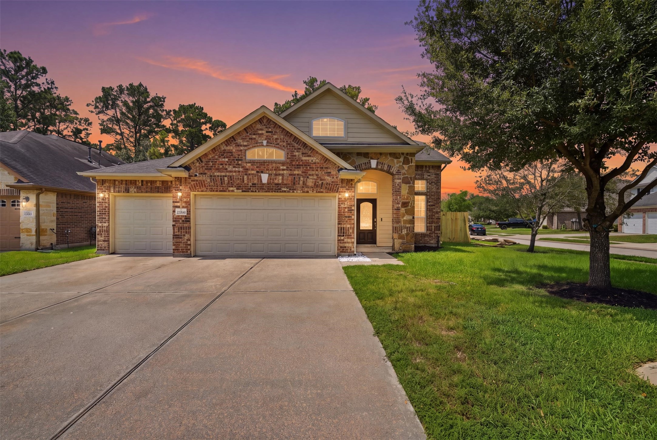 Golden-hour glow on the same brick-and-stone facade: warm porch lights, arched windows and a front walk that says welcome home. Virtual twilight enhancement; sky and lighting digitally edited. Golden-hour glow on the same brick-and-stone facade: warm porch lights, arched windows and a front walk that says welcome home. Virtual twilight enhancement; sky and lighting digitally edited.