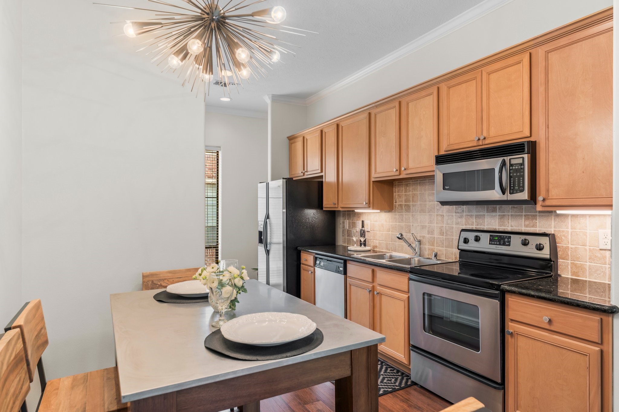 New kitchen light fixtures and stainless steel appliances.