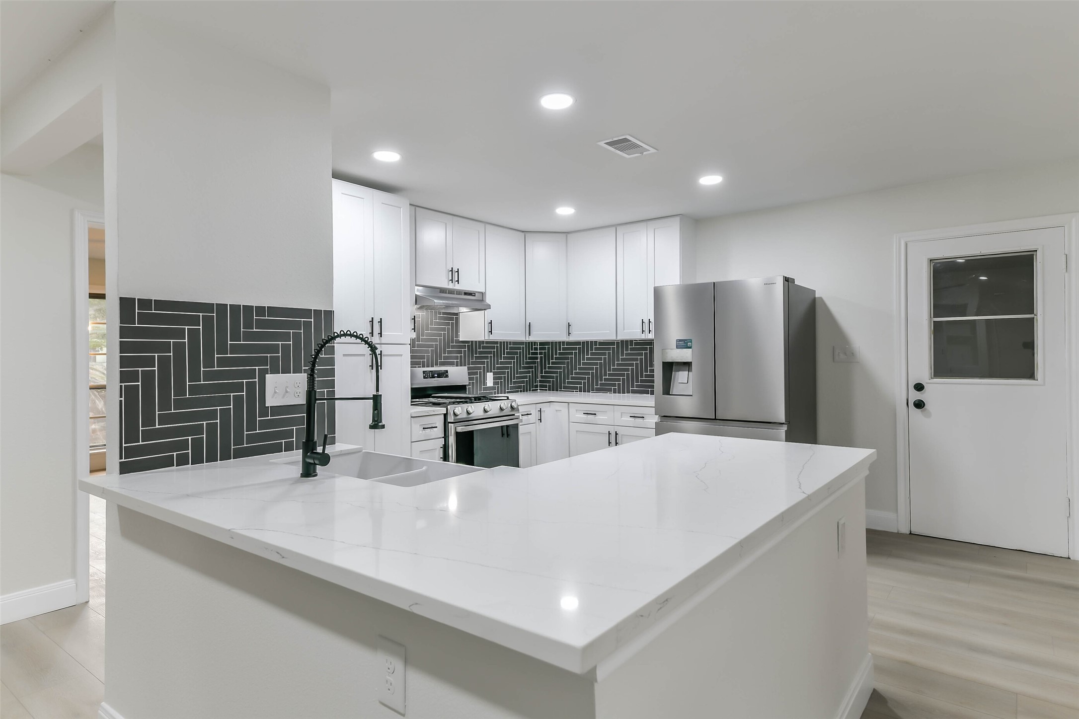 Kitchen Door Leads into the oversized garage