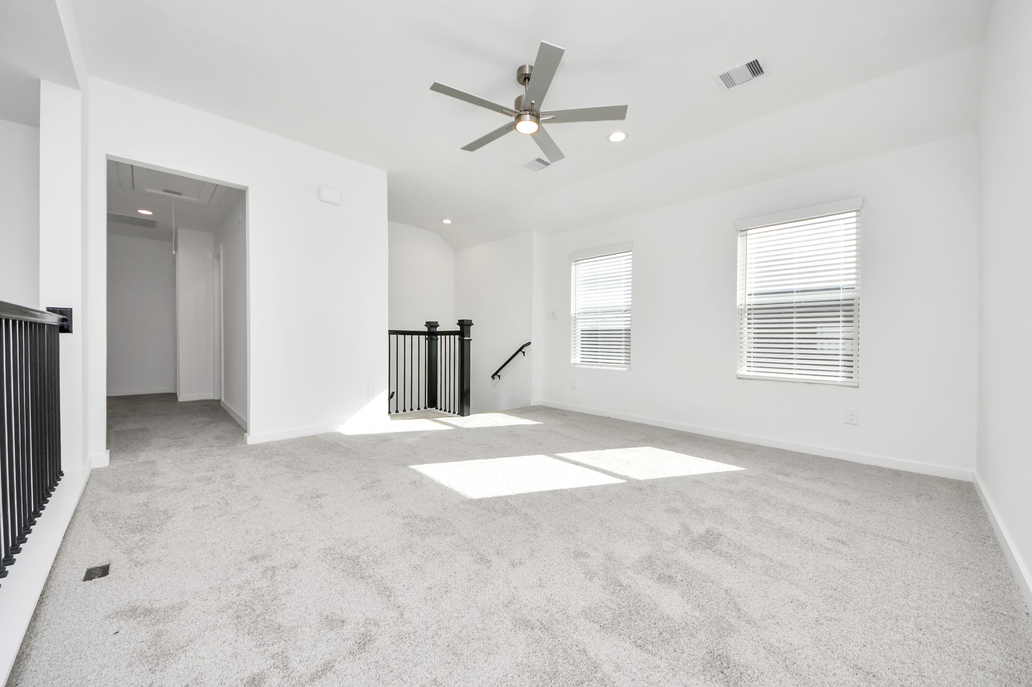 Ascend to relaxation in this fantastic game room! Ideal for both casual gatherings and adult gaming, it boasts plush carpet, lofty ceilings, custom paint, and ample windows for abundant natural light. Sample photo of completed home with similar floor plan. Actual colors and selections may vary.