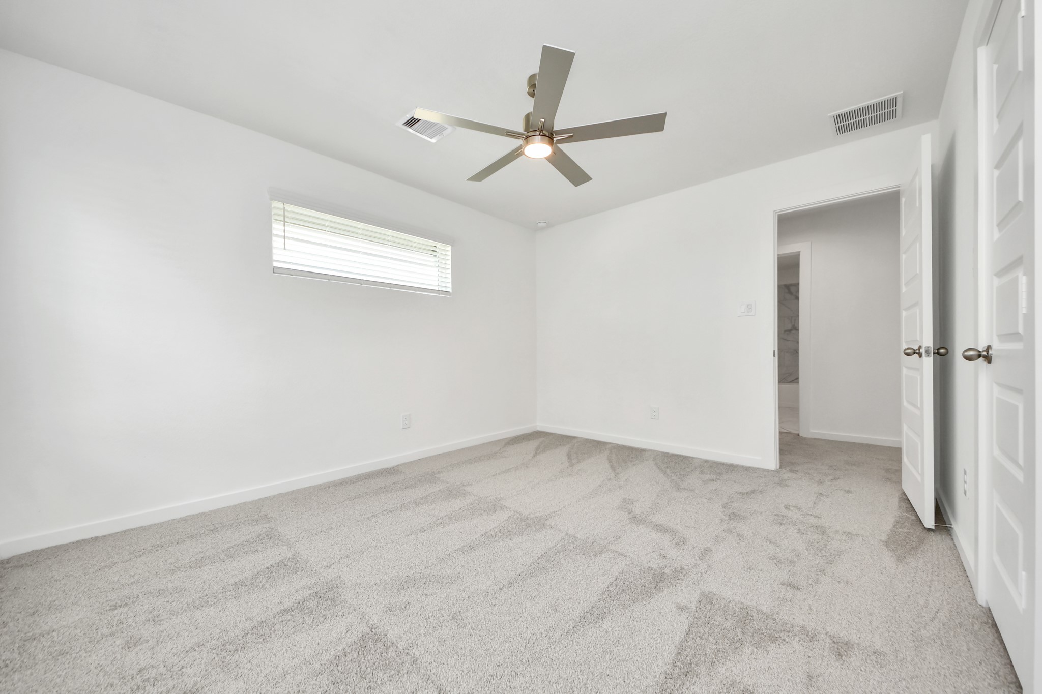 Generously sized secondary bedrooms featuring spacious closets, soft and inviting carpeting underfoot, large windows allowing plenty of natural light, and the added touch of privacy blinds for your personal retreat. v