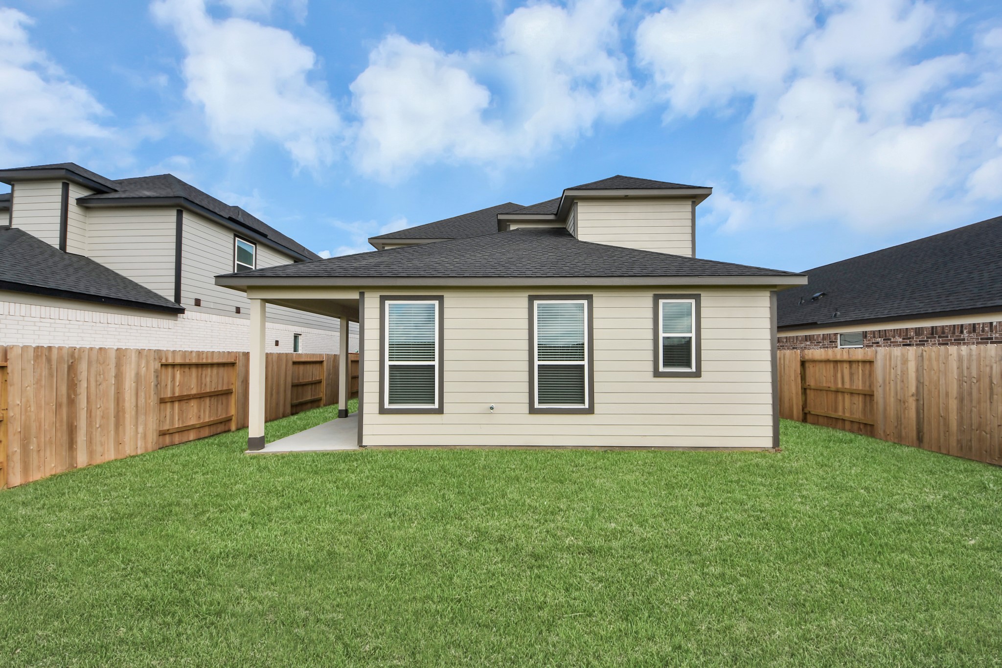 Backyard retreat, offering an abundance of space for kids to play and explore. The possibilities are endless in this outdoor haven, where the joy of open-air activities and family gatherings awaits. Sample photo of completed home with similar floor plan. Actual colors and selections may vary.