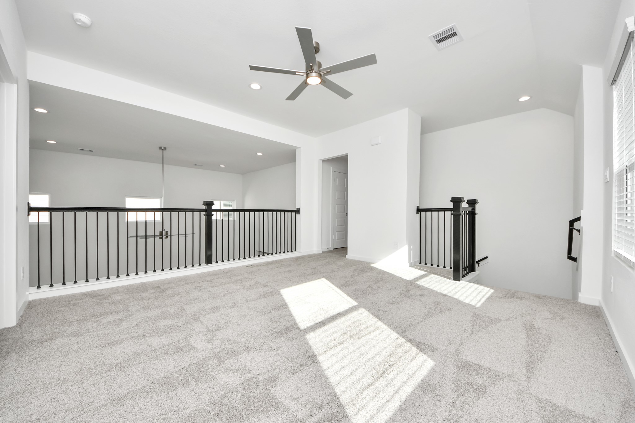 Come upstairs and enjoy a day of leisure in this fabulous game room! This is the perfect hangout spot or adult game room! Features plush carpet, high ceilings, custom paint and windows for plenty of natural light. Sample photo of completed home with similar floor plan. Actual colors and selections may vary.