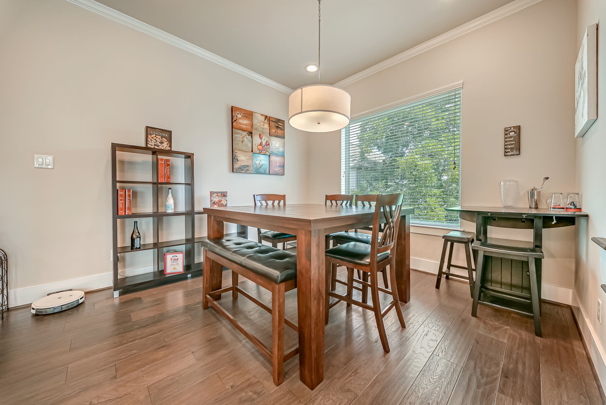 Spacious dining area featuring abundant natural light and elevated neighborhood views through expansive windows.