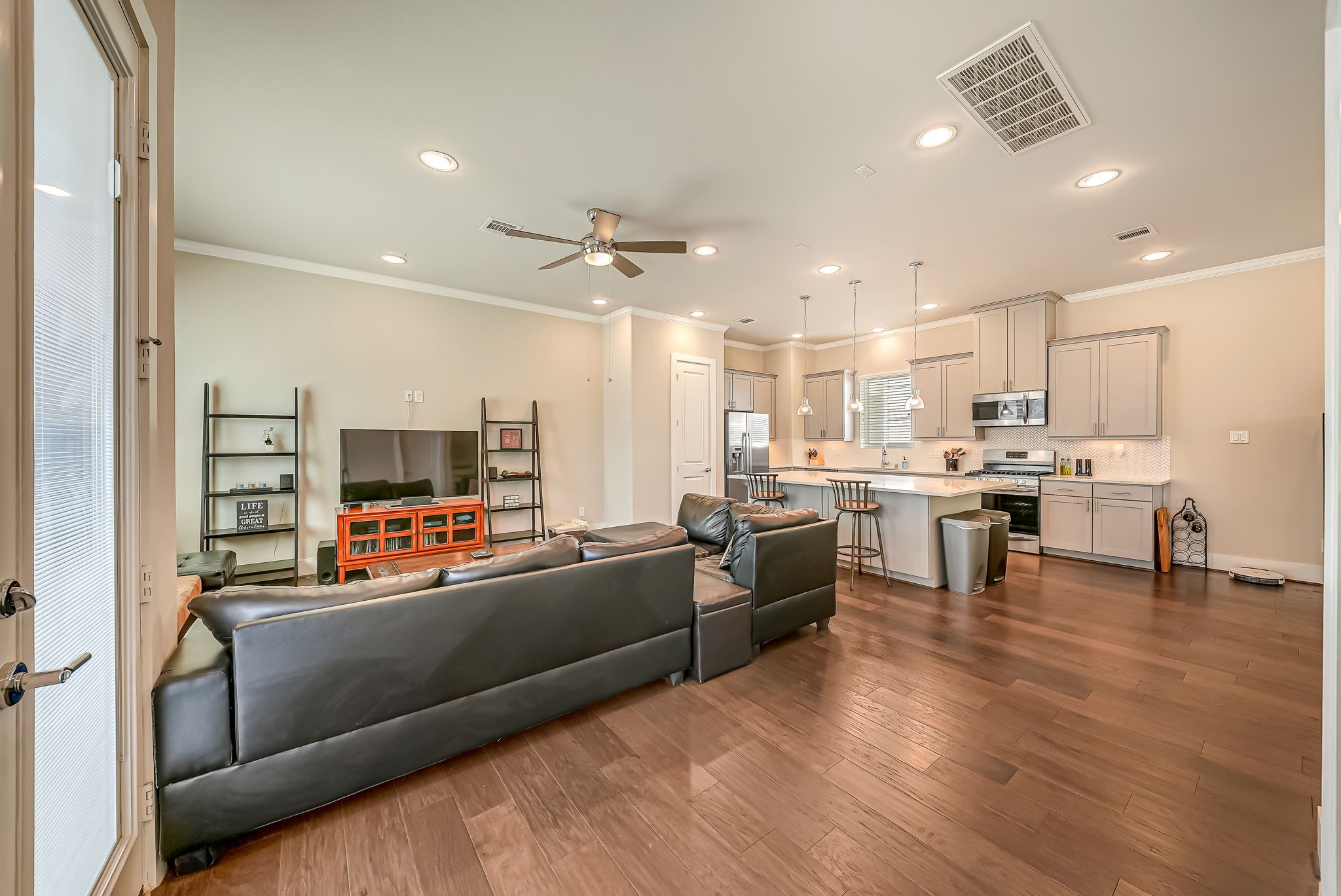 Open-concept family room designed for entertaining, featuring direct access to the gourmet kitchen and oversized island.