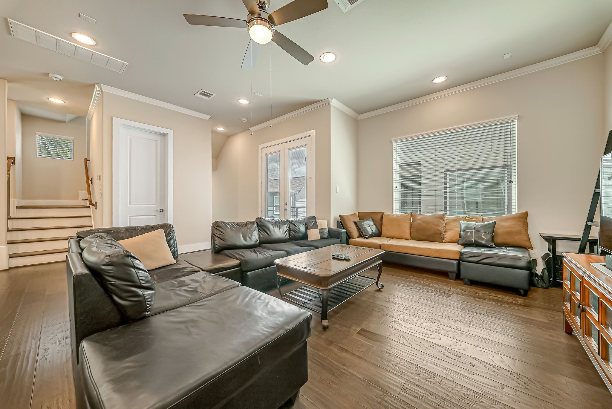 Spacious living area with French doors opening to the private balcony, offering additional indoor-outdoor living space.