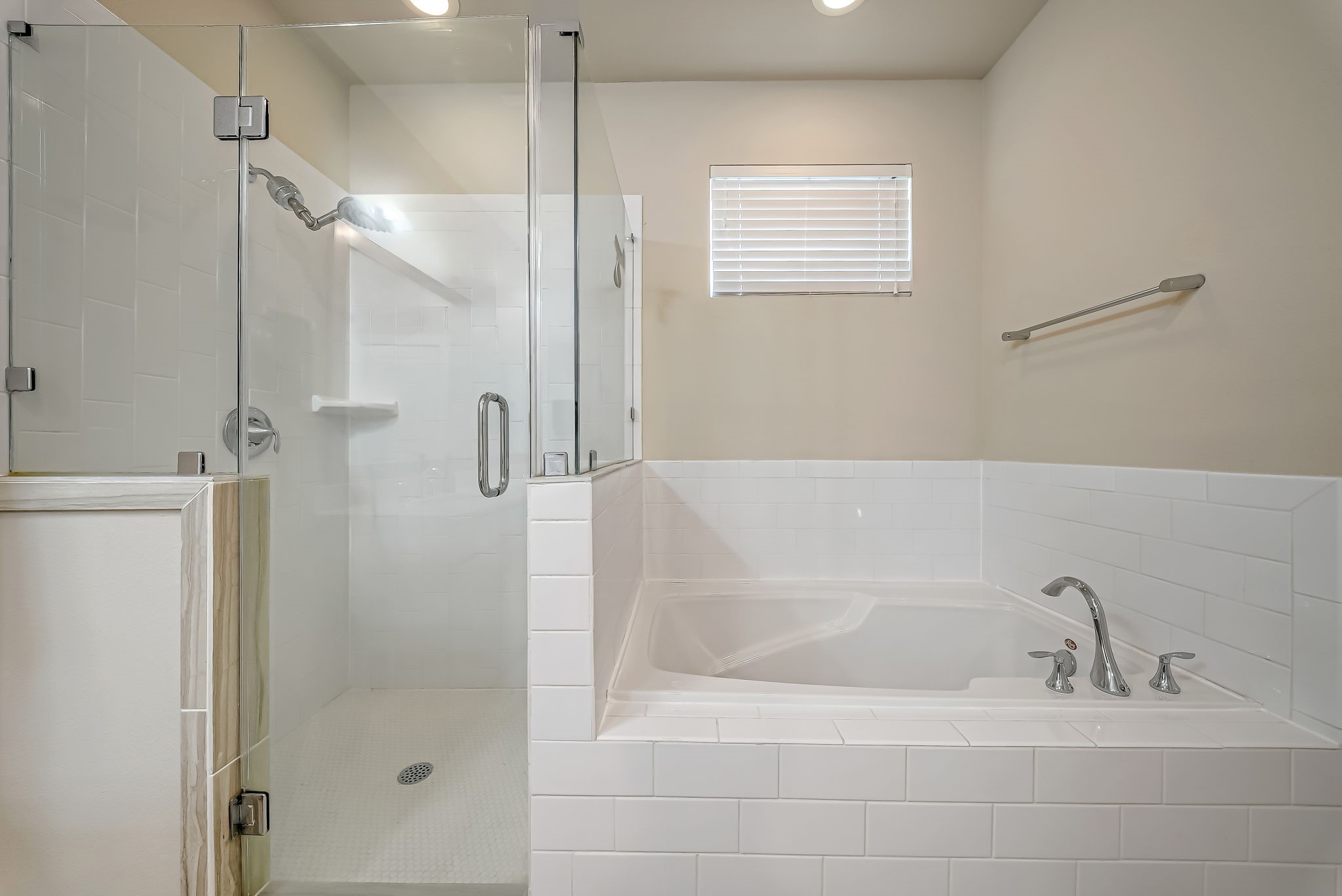 Luxurious primary bath with oversized walk-in shower and relaxing soaking tub.