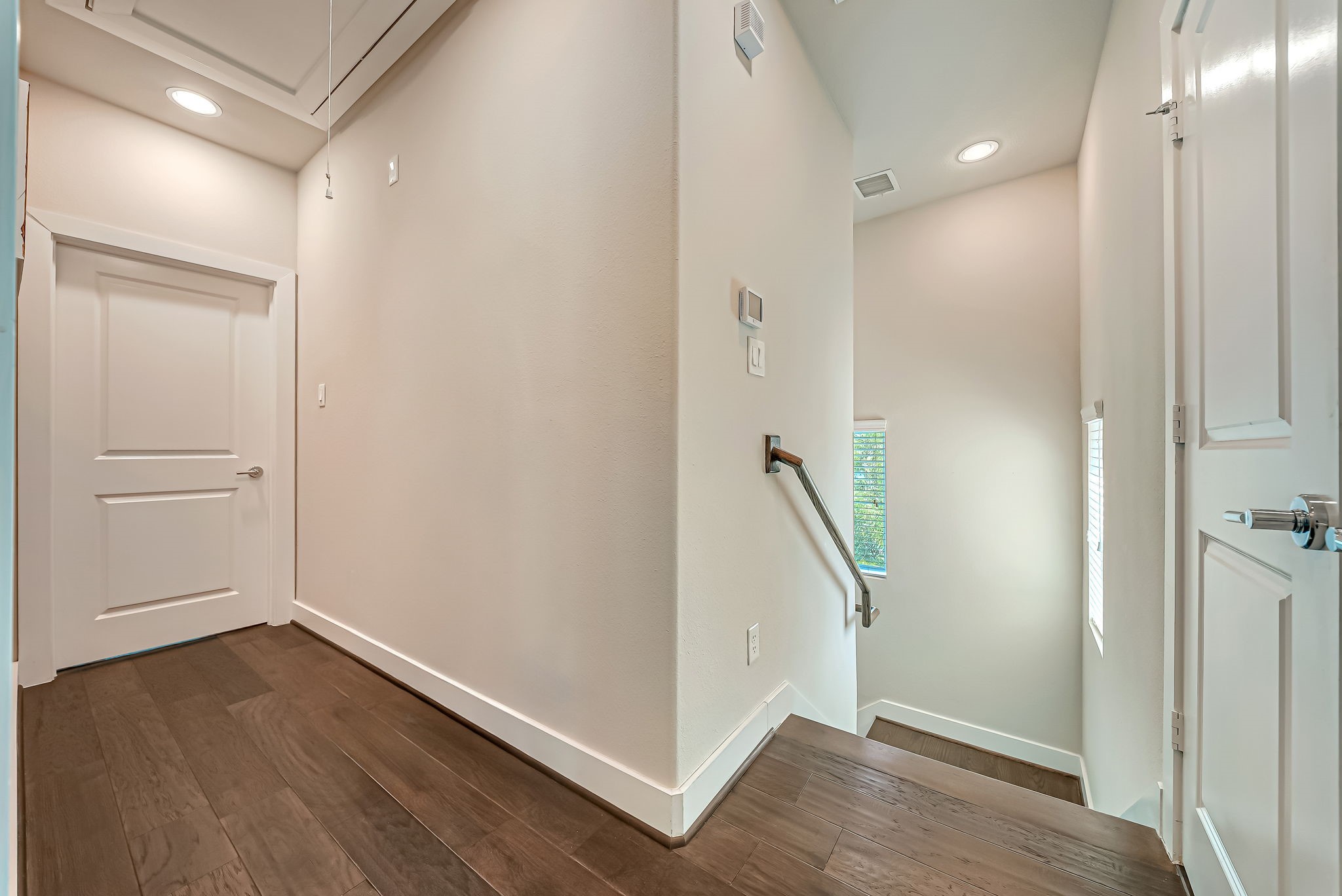 Interior stairway connecting all levels with architectural detailing and natural light.