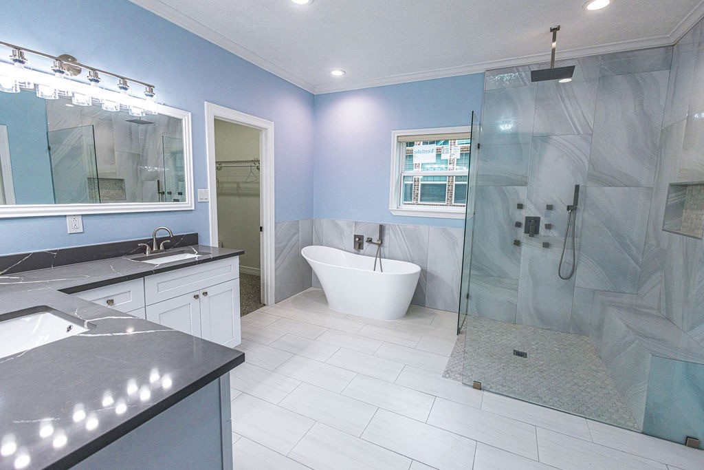 Primary suite has free standing tub and really spacious shower