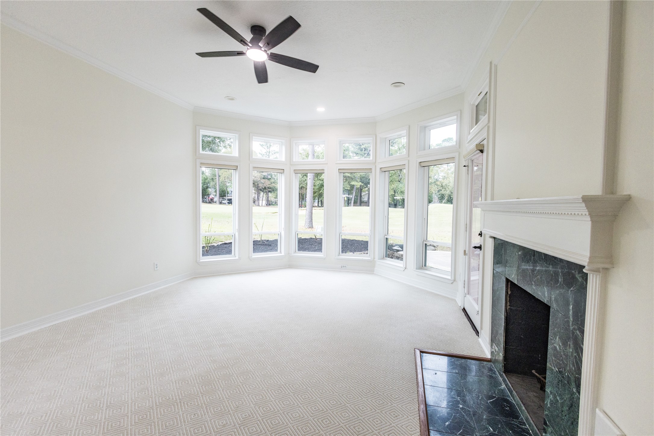 Primary bedroom with its own fireplace looking at the Golfcourse
