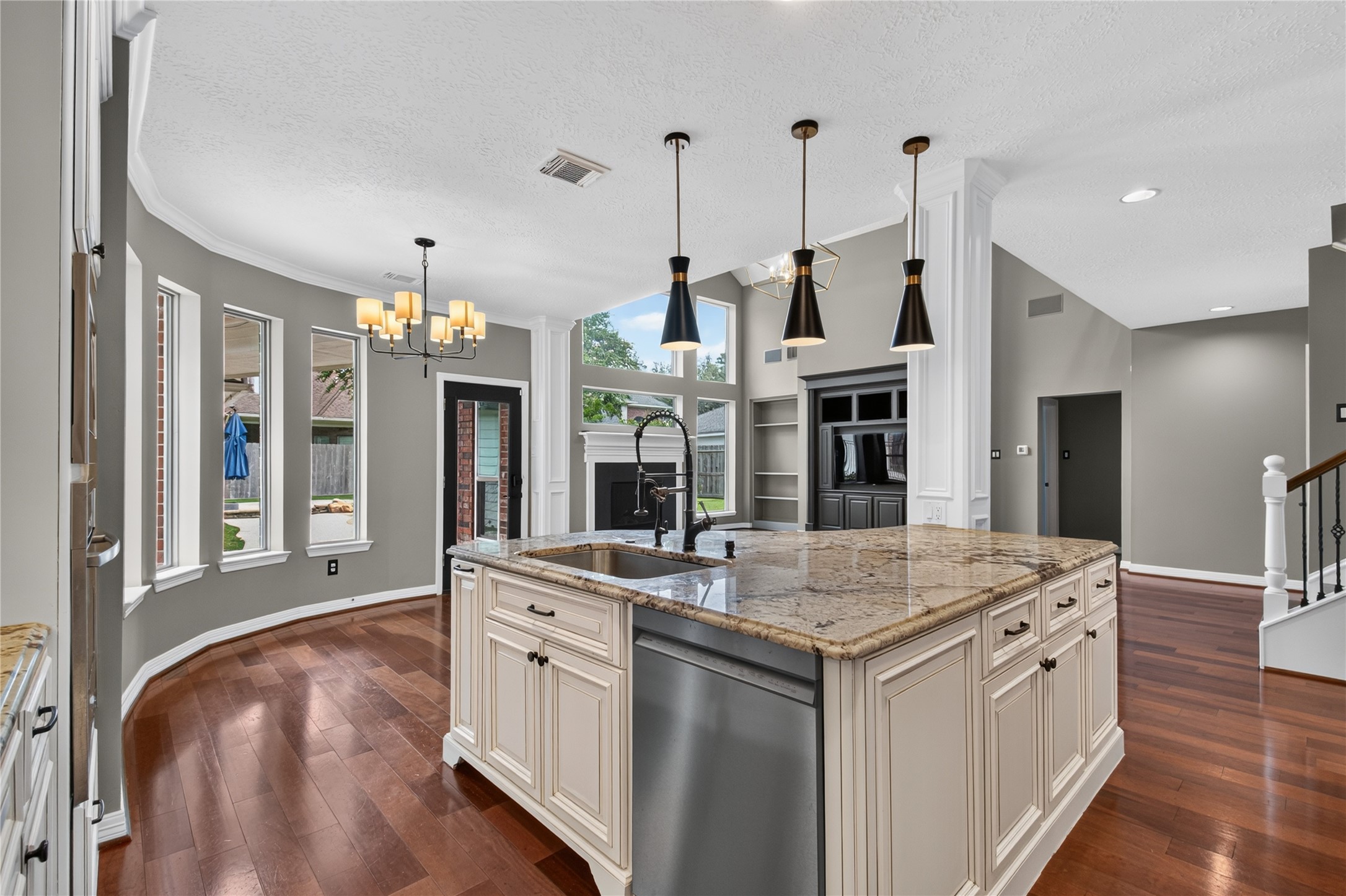 Oversized island anchors the kitchen with generous workspace, storage and seating for casual meals.