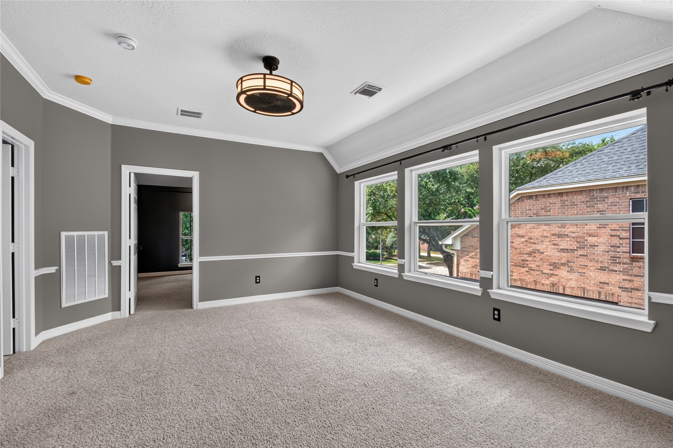 Spacious upstairs game room offers a flexible second living area with abundant natural light.