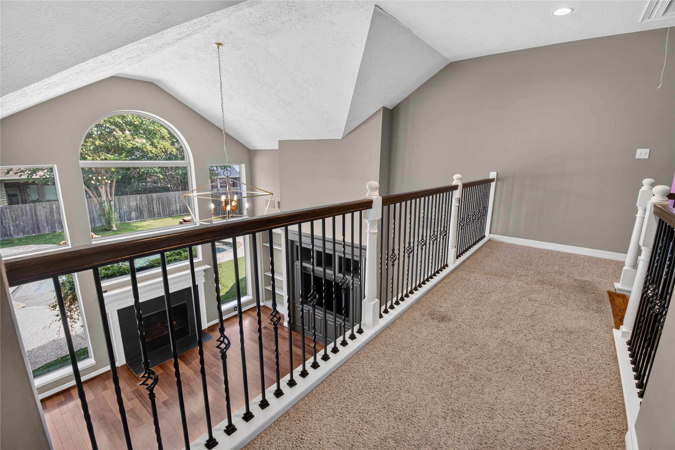Upstairs overlook showcases the dramatic two-story family room and the homes open, light-filled design.