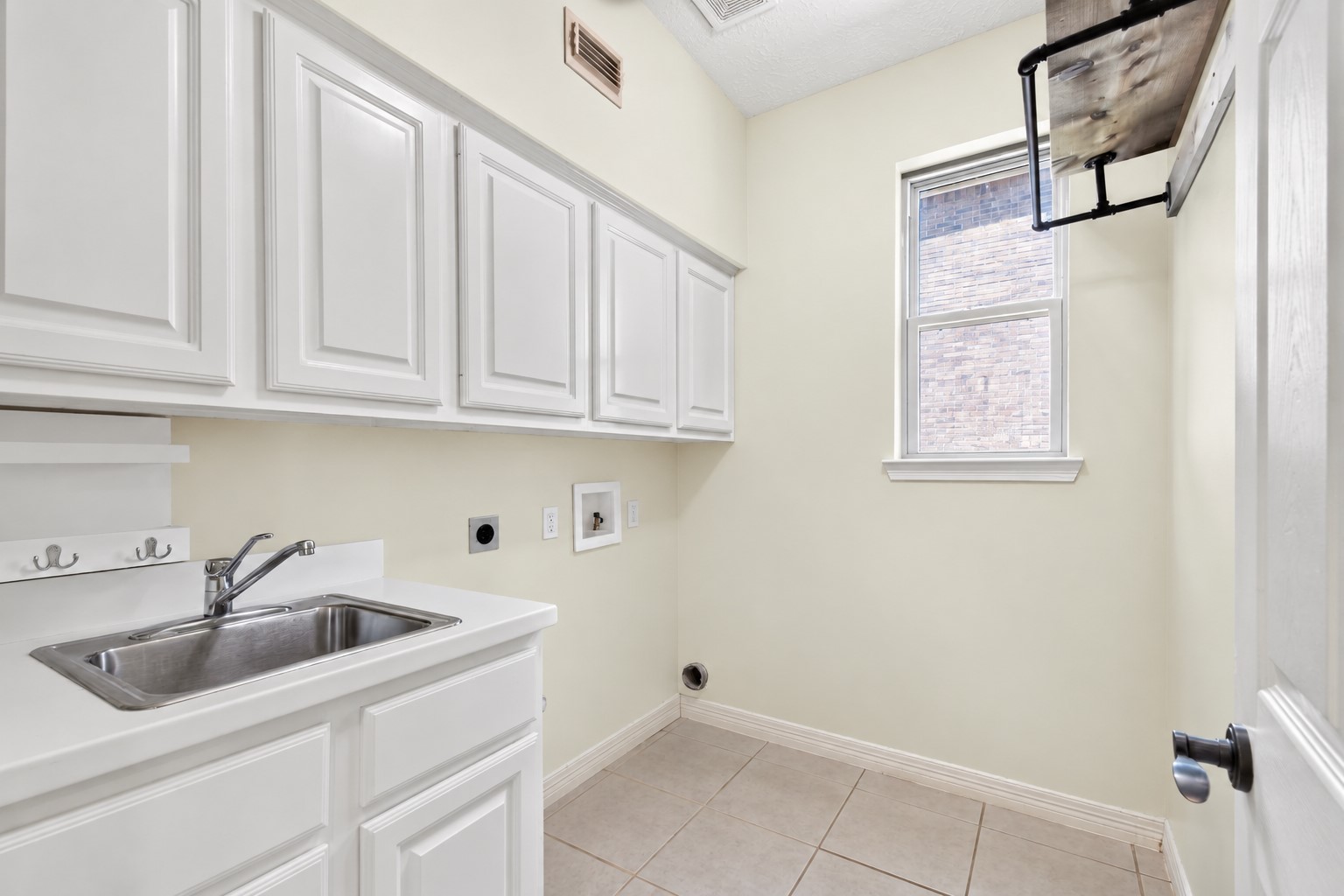 Spacious laundry room with added storage.