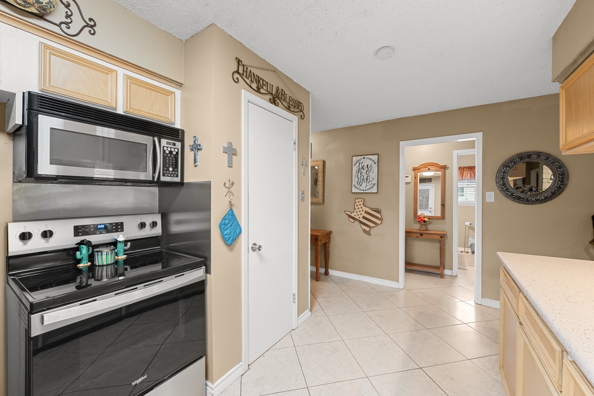 Functional kitchen layout featuring stainless steel appliances, extensive cabinetry, and generous counter space for meal prep and storage. The open design and easy access to adjacent living areas create a seamless flow throughout the home.