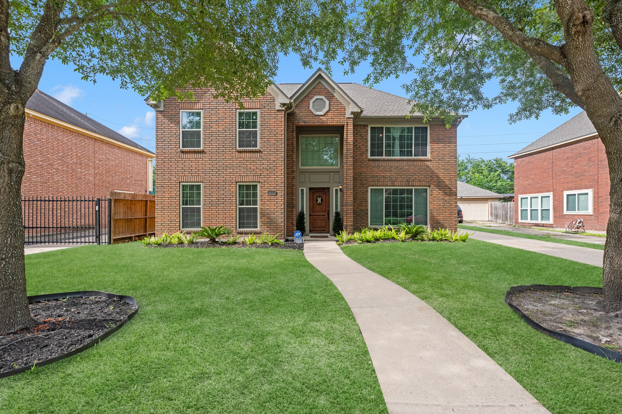 Large front yard with a long driveway to the detached garage.