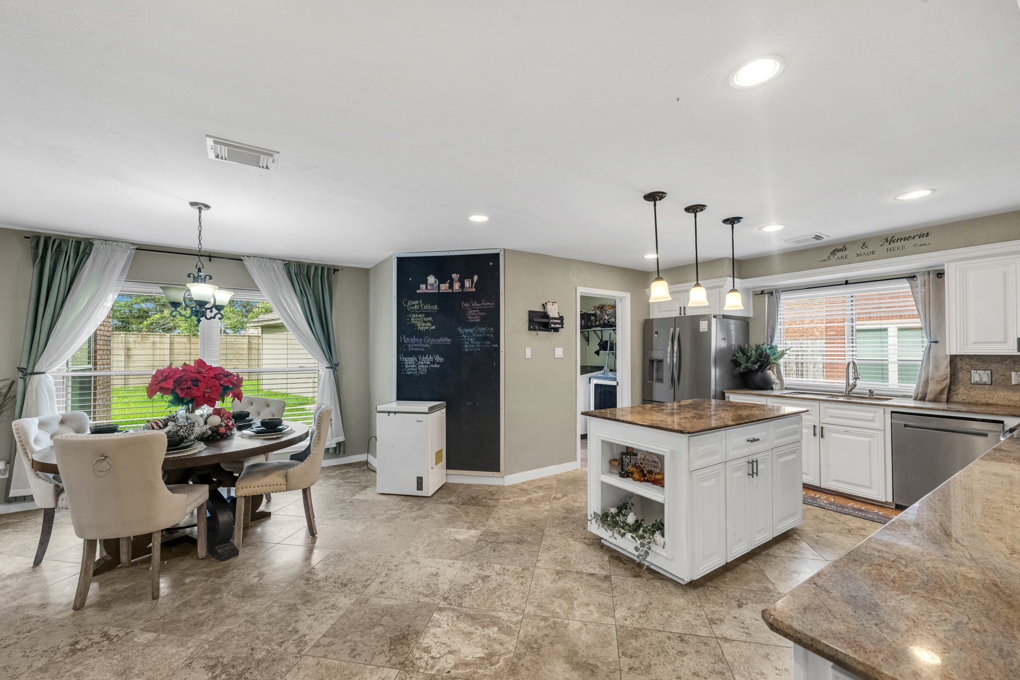 Breakfast area with large window for light, the kitchen is large with beautiful countertops and plenty of storage.