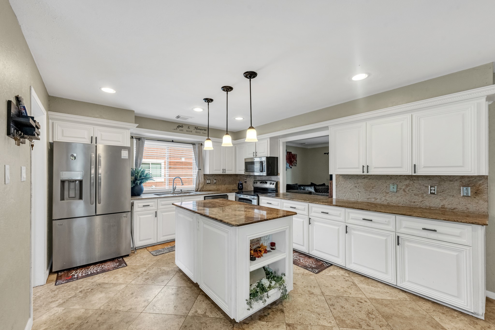 Large kitchen with granite countertops and a large island